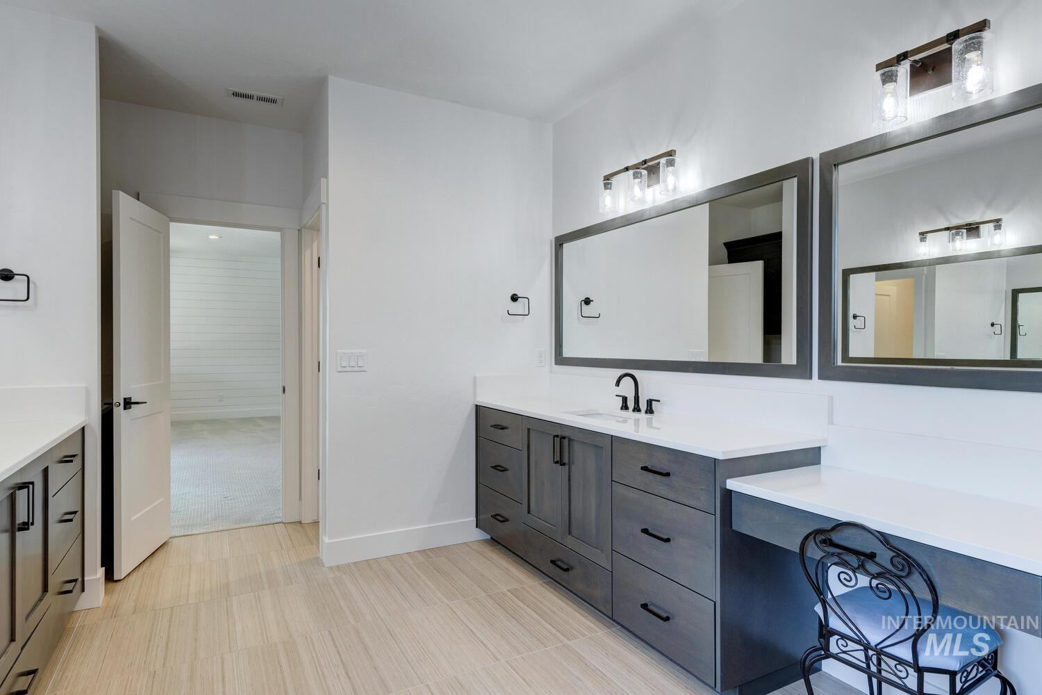 Full bath featuring vanity and baseboards