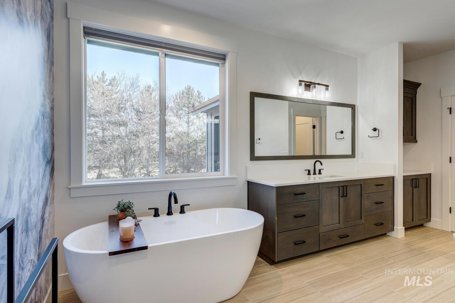 Bathroom with vanity and a soaking tub