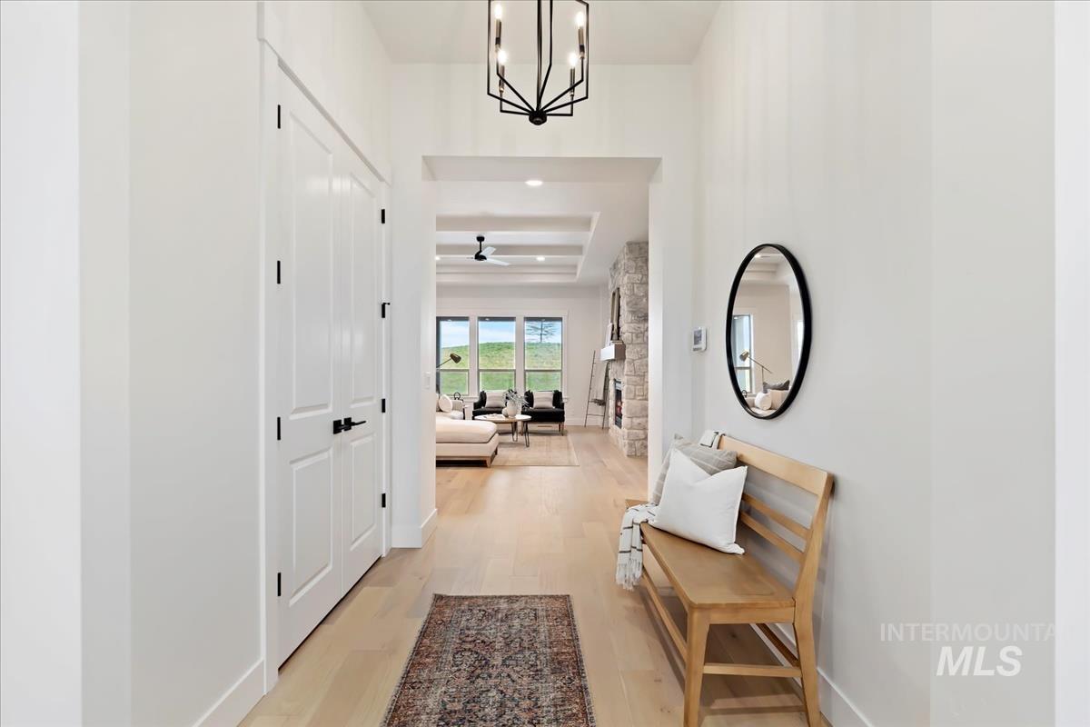 Hallway featuring a chandelier and light wood-style floors