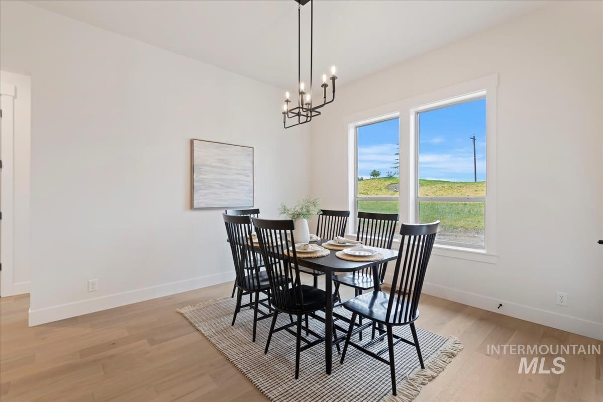 Dining area featuring light wood-style flooring and a chandelier