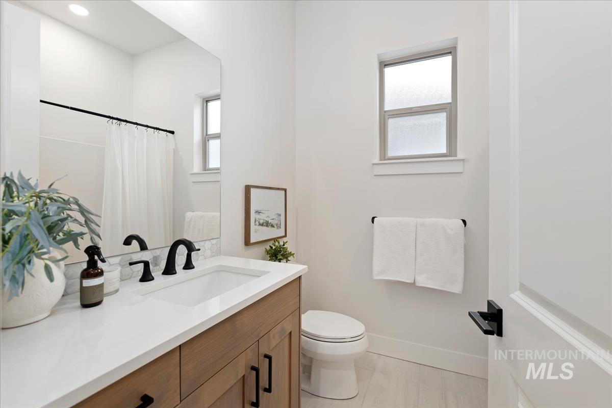 Bathroom with vanity, a shower with curtain, and light tile patterned floors