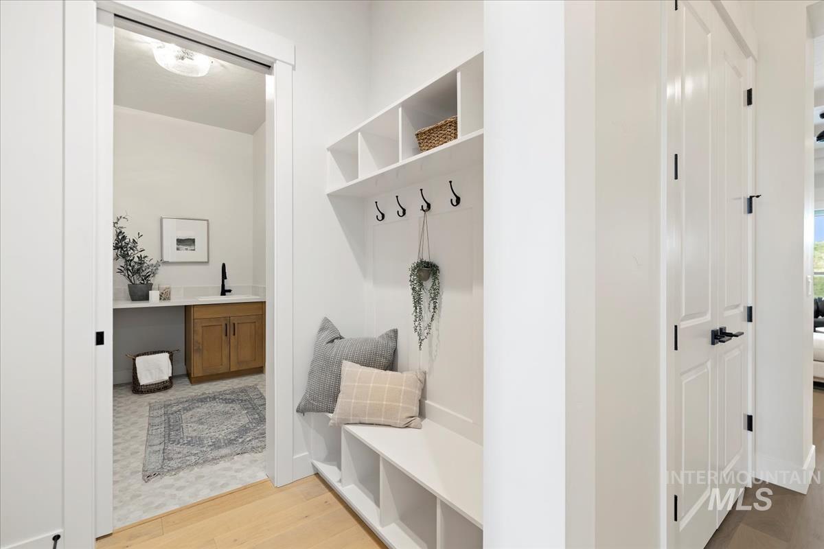 Mudroom featuring light wood-style flooring and a sink