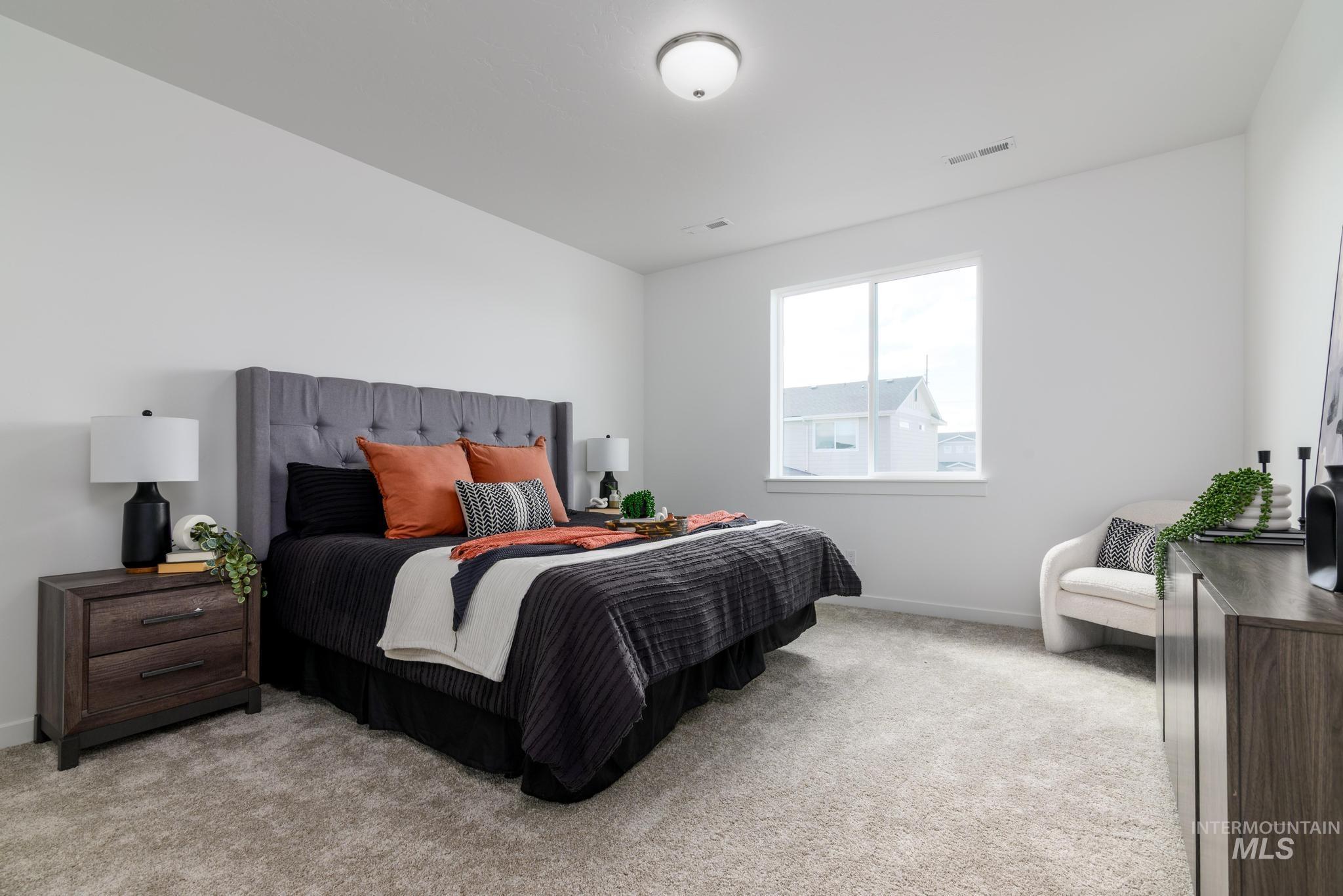Bedroom featuring light colored carpet