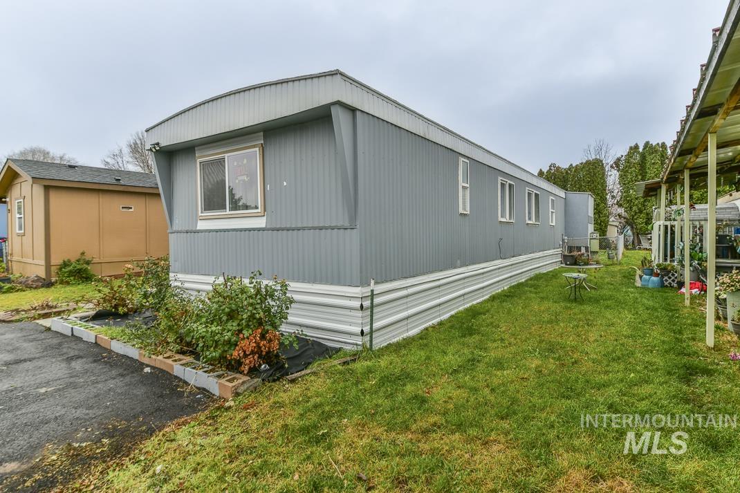 View of side of home with a lawn