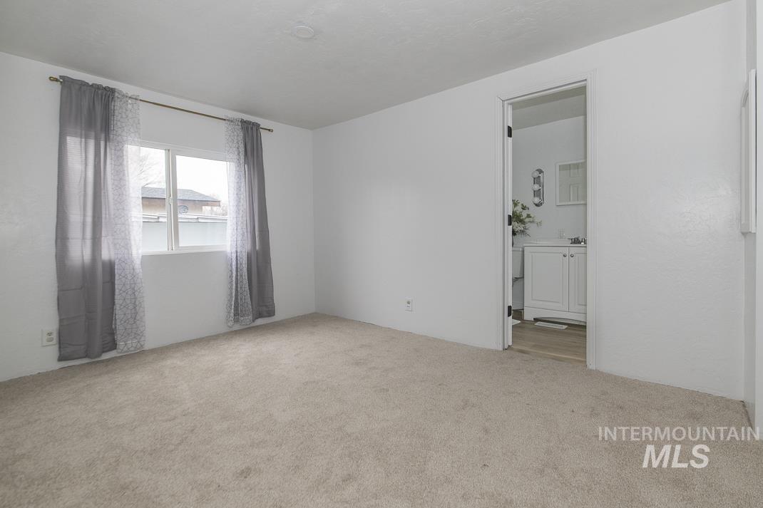 Empty room featuring light colored carpet