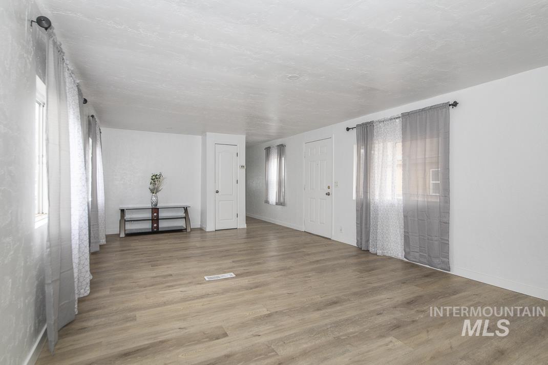 Spare room with light wood-style floors and baseboards