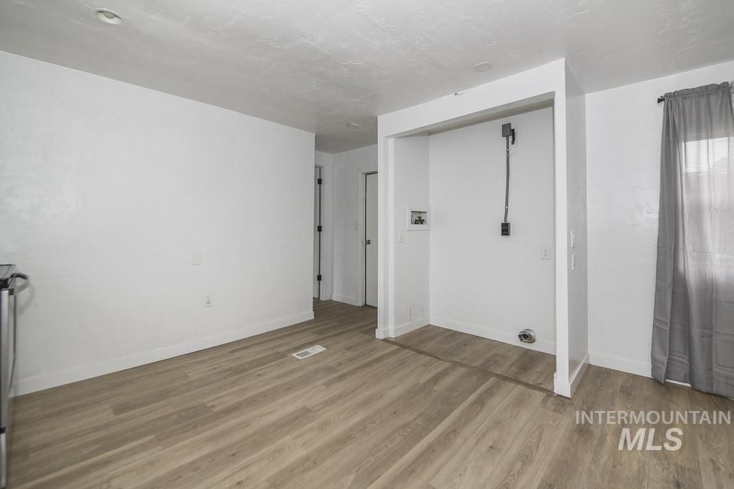 Spare room featuring light wood-style flooring and a textured ceiling