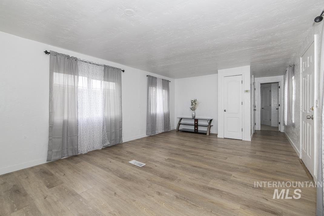 Empty room with wood finished floors and baseboards