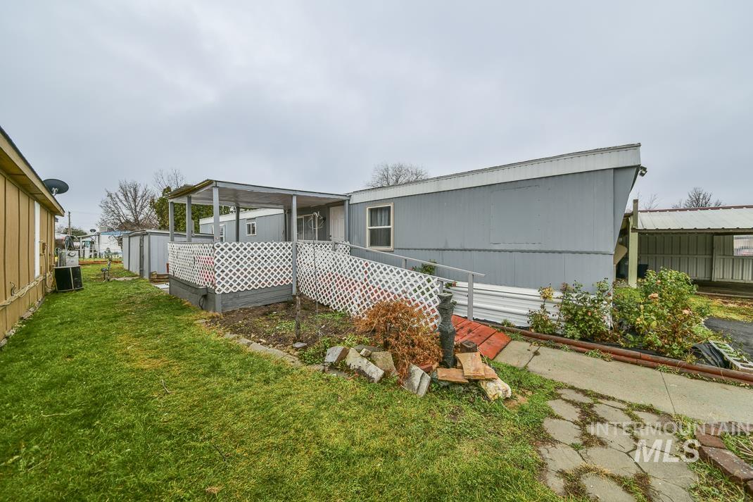 Rear view of property featuring a lawn