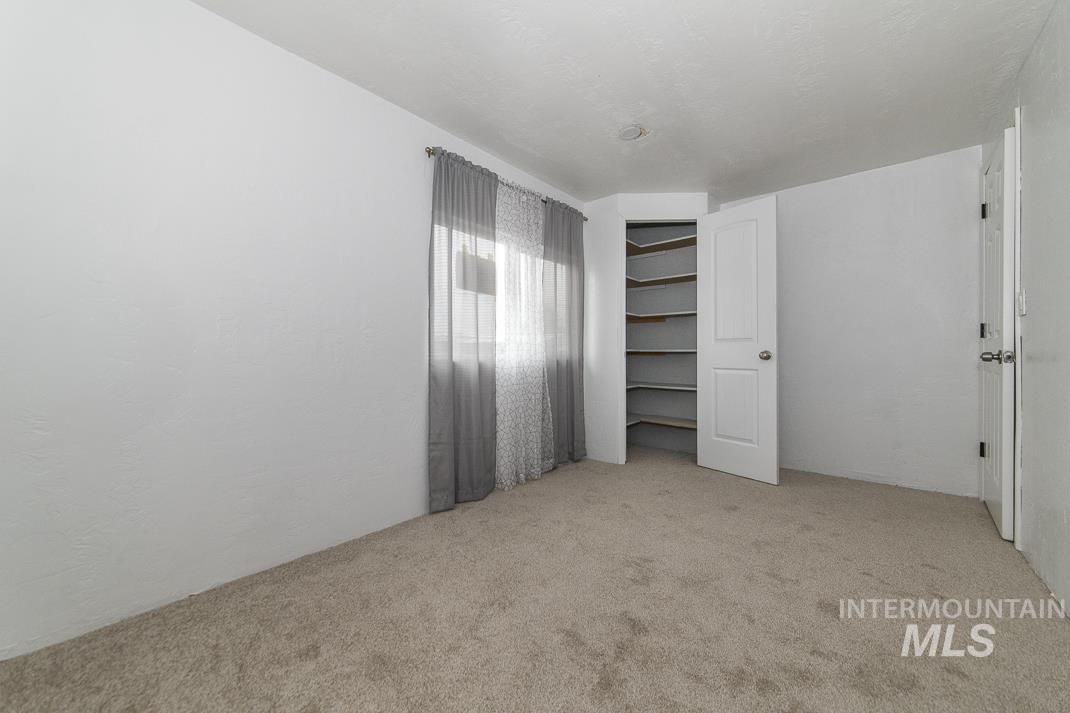 Unfurnished bedroom with a closet and light colored carpet