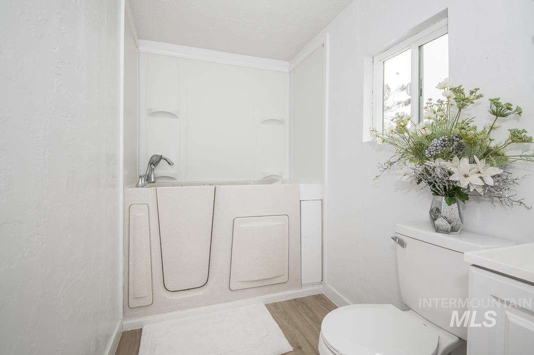 Bathroom featuring a bathtub, light wood-type flooring, and vanity