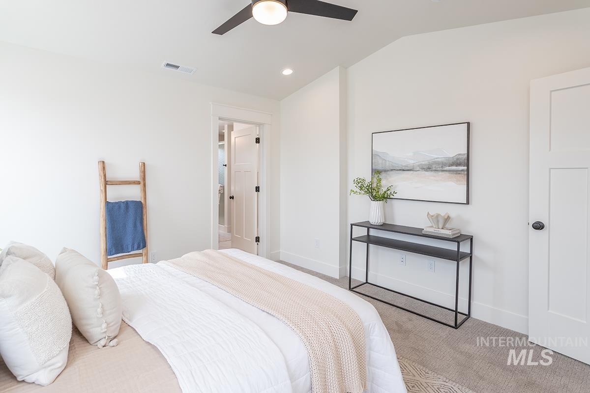 Bedroom with vaulted ceiling, carpet, ceiling fan, and recessed lighting