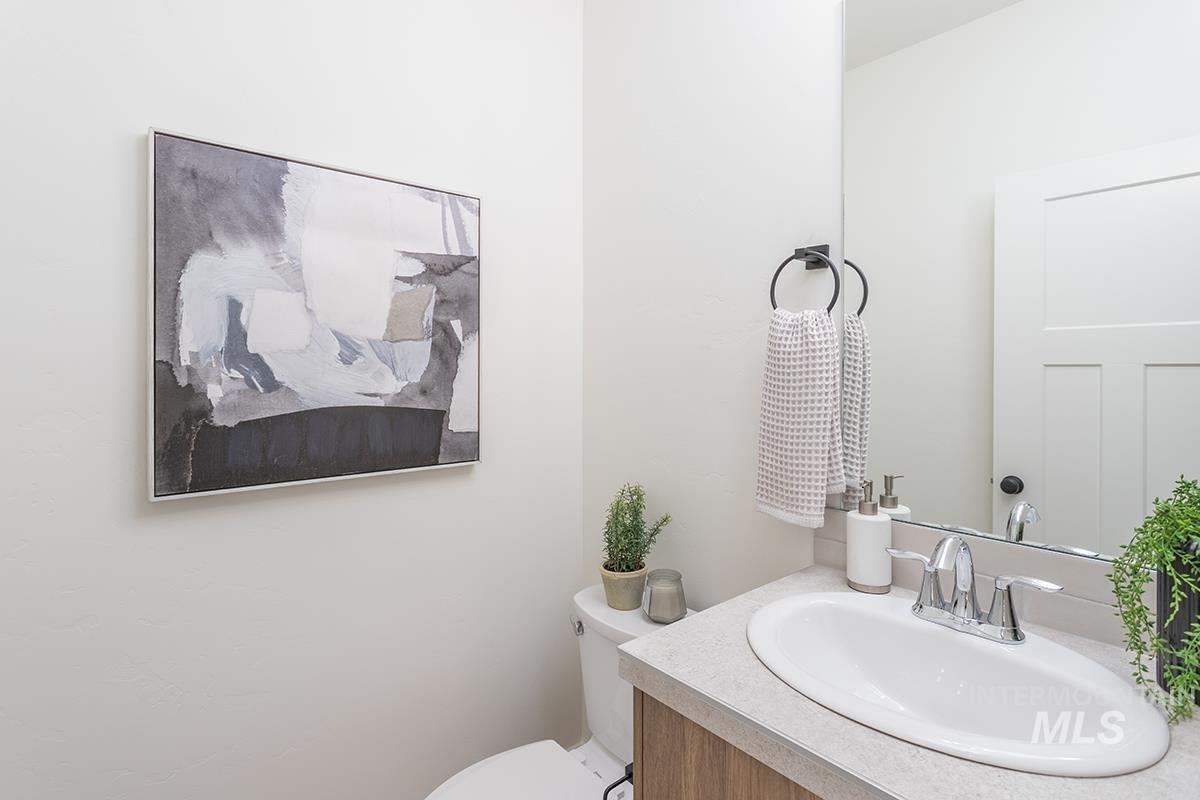 Half bath featuring vanity and toilet