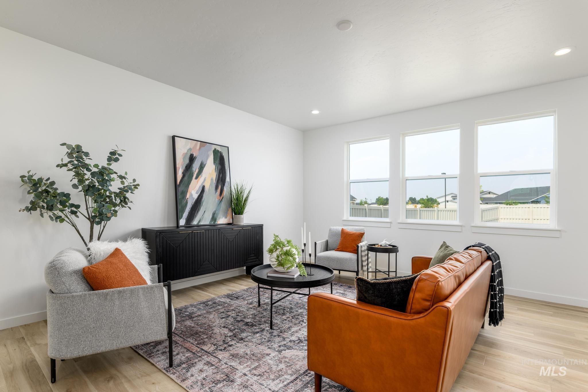 Living area with light wood-style floors and recessed lighting