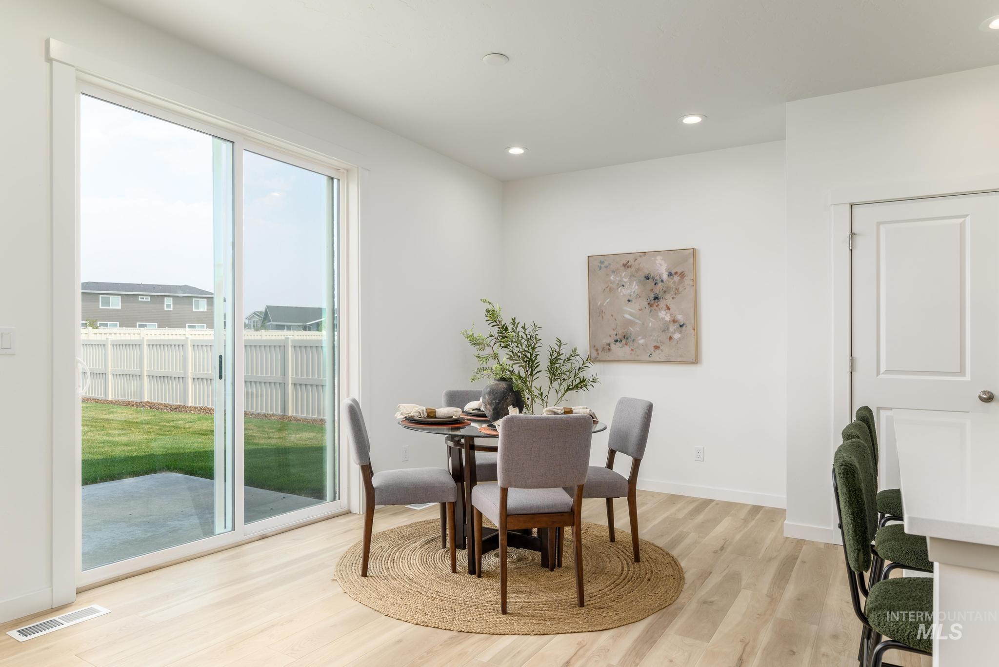 Dining area featuring light wood-style flooring and recessed lighting