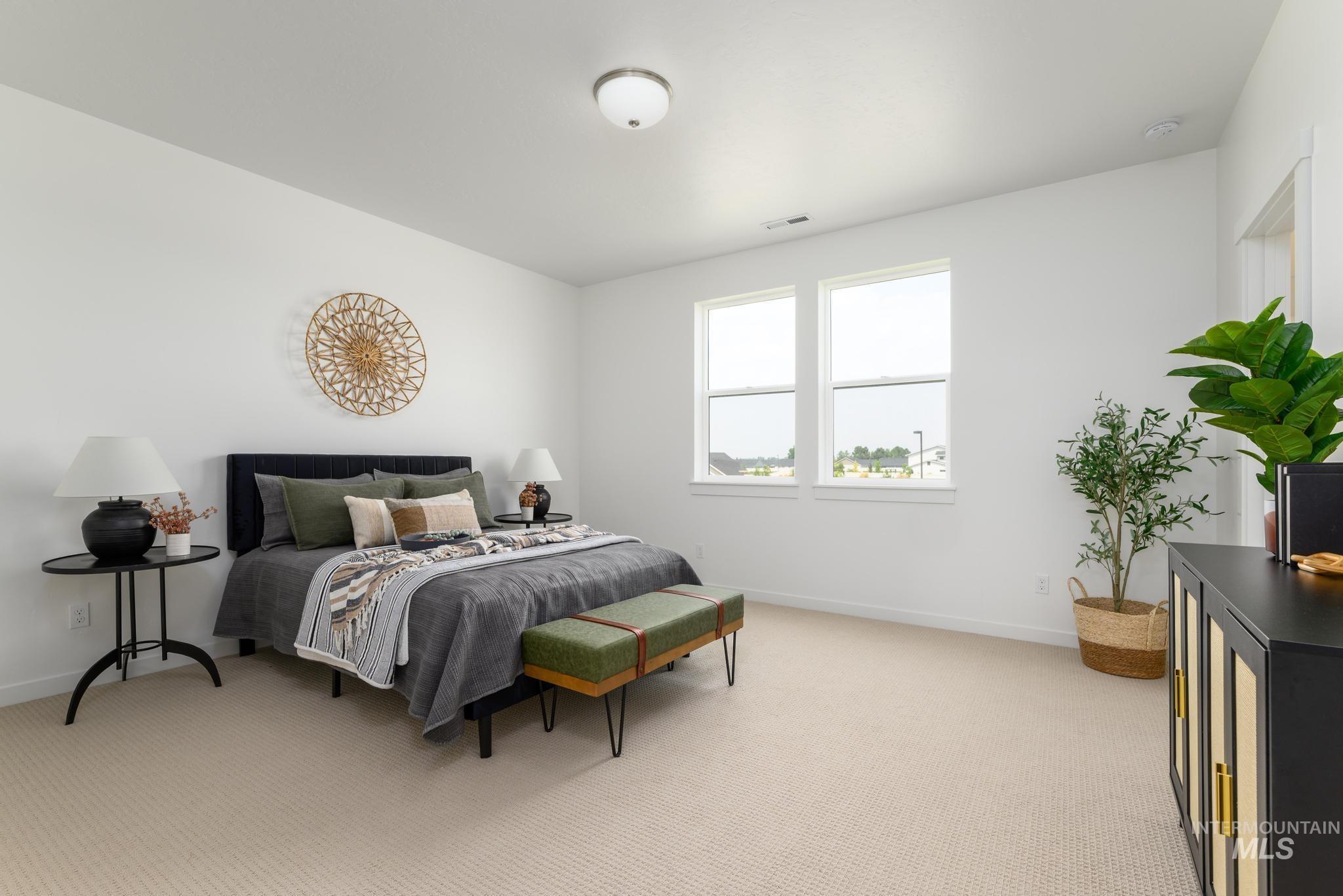 Bedroom featuring light colored carpet and baseboards