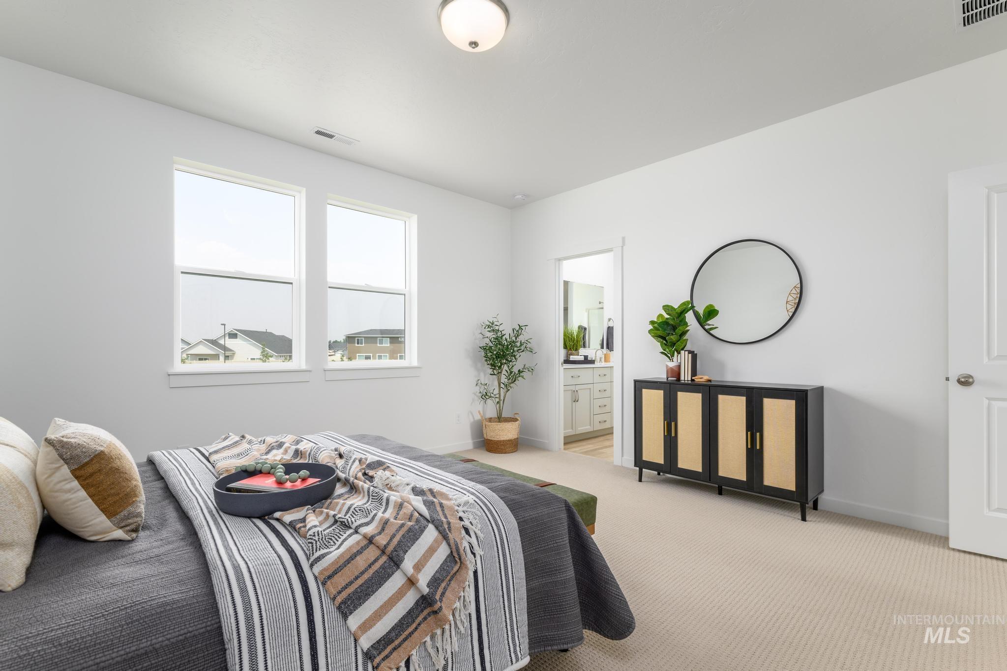 Bedroom with connected bathroom and carpet