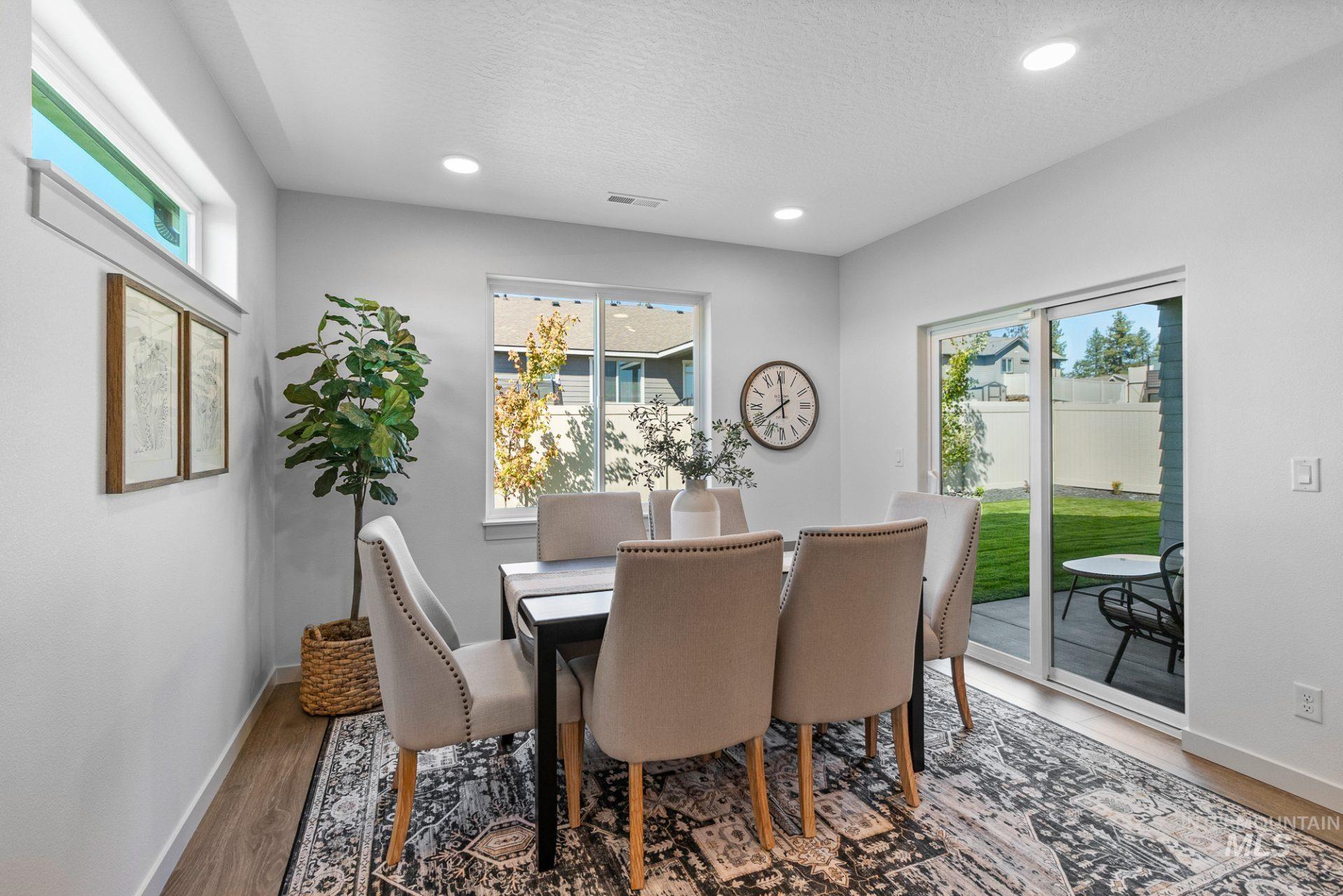 Dining space featuring healthy amount of natural light, recessed lighting, light wood-style flooring, and a textured ceiling