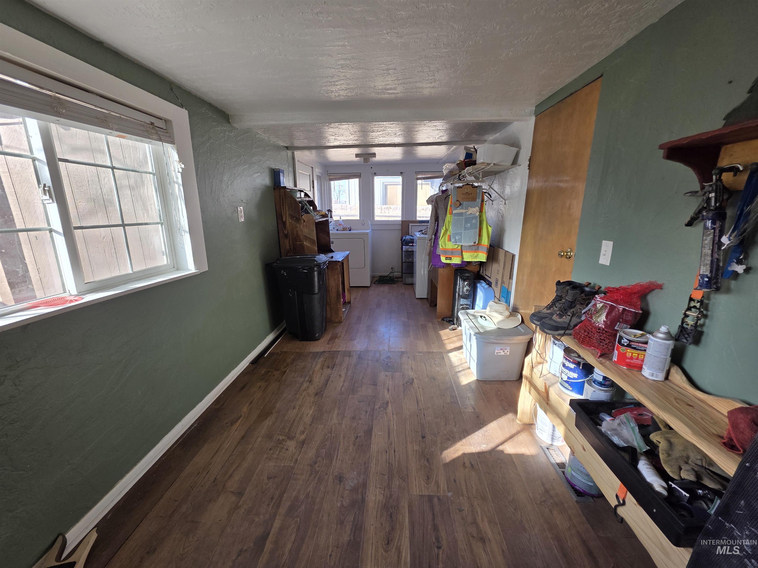 Hall featuring dark wood finished floors and a textured ceiling