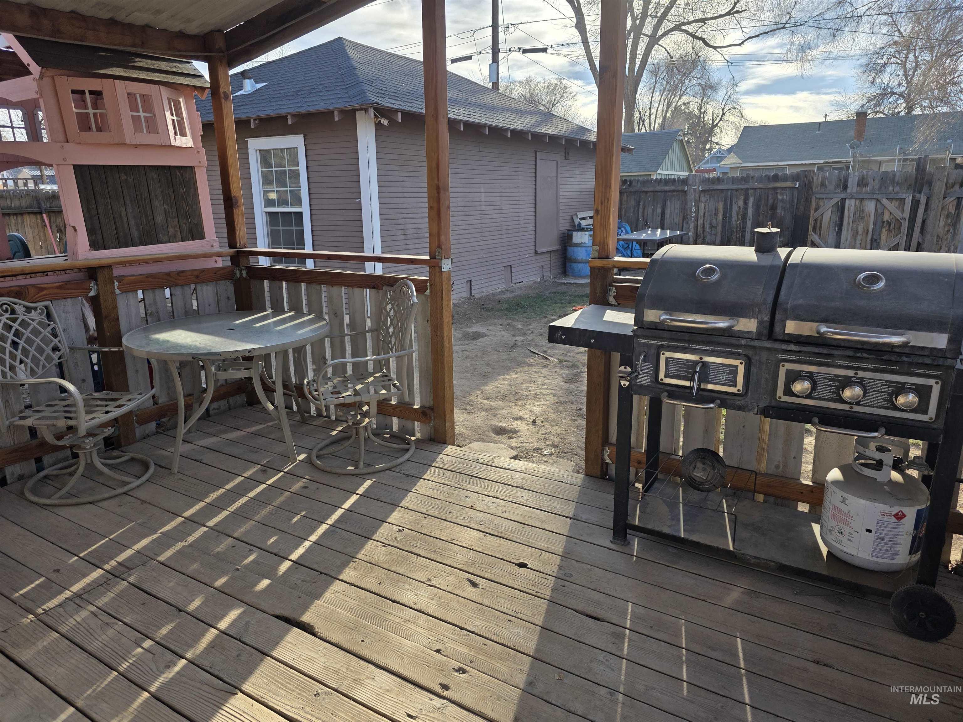 Wooden terrace featuring area for grilling