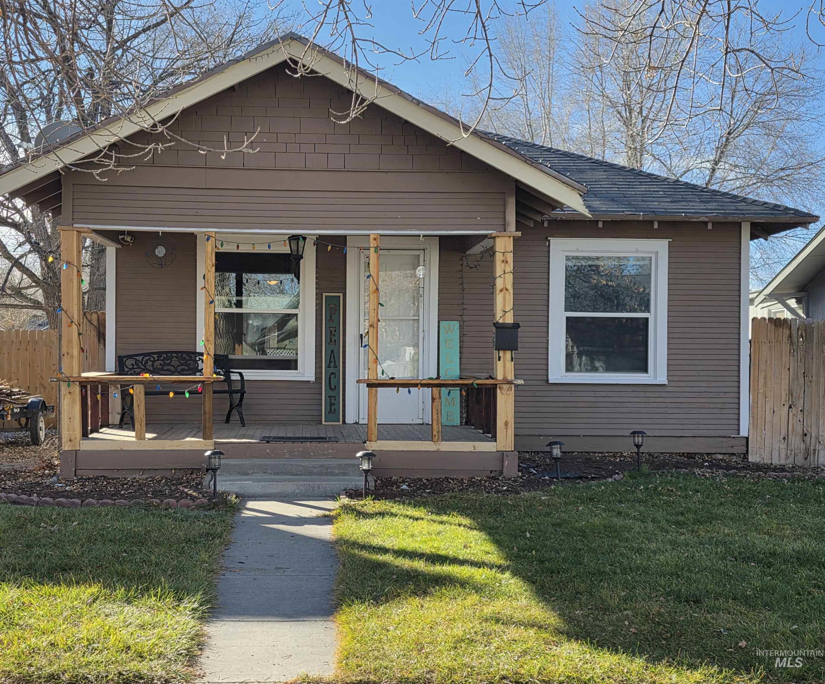 Bungalow-style home with a porch and roof with shingles
