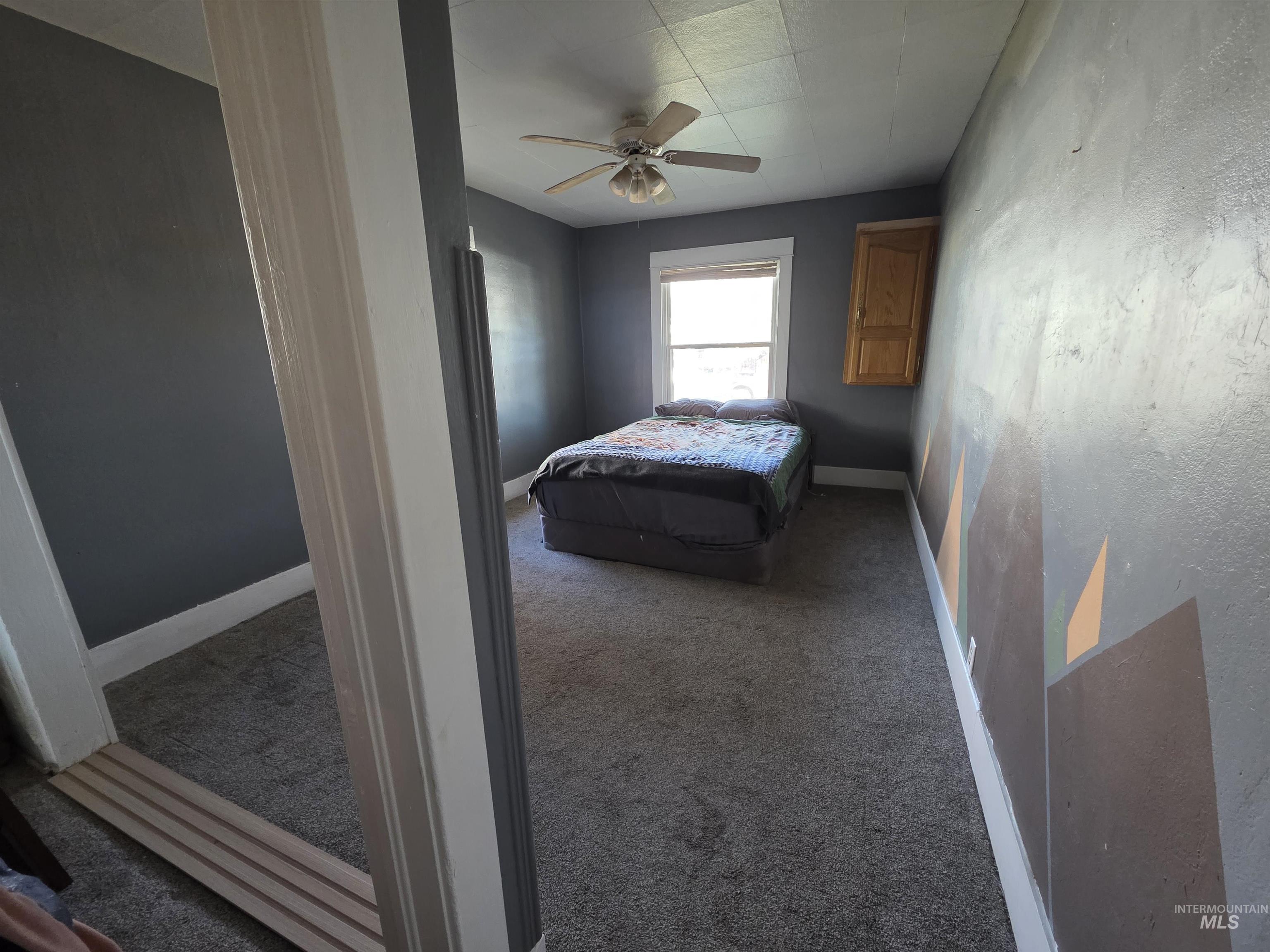 Bedroom with carpet flooring and a ceiling fan