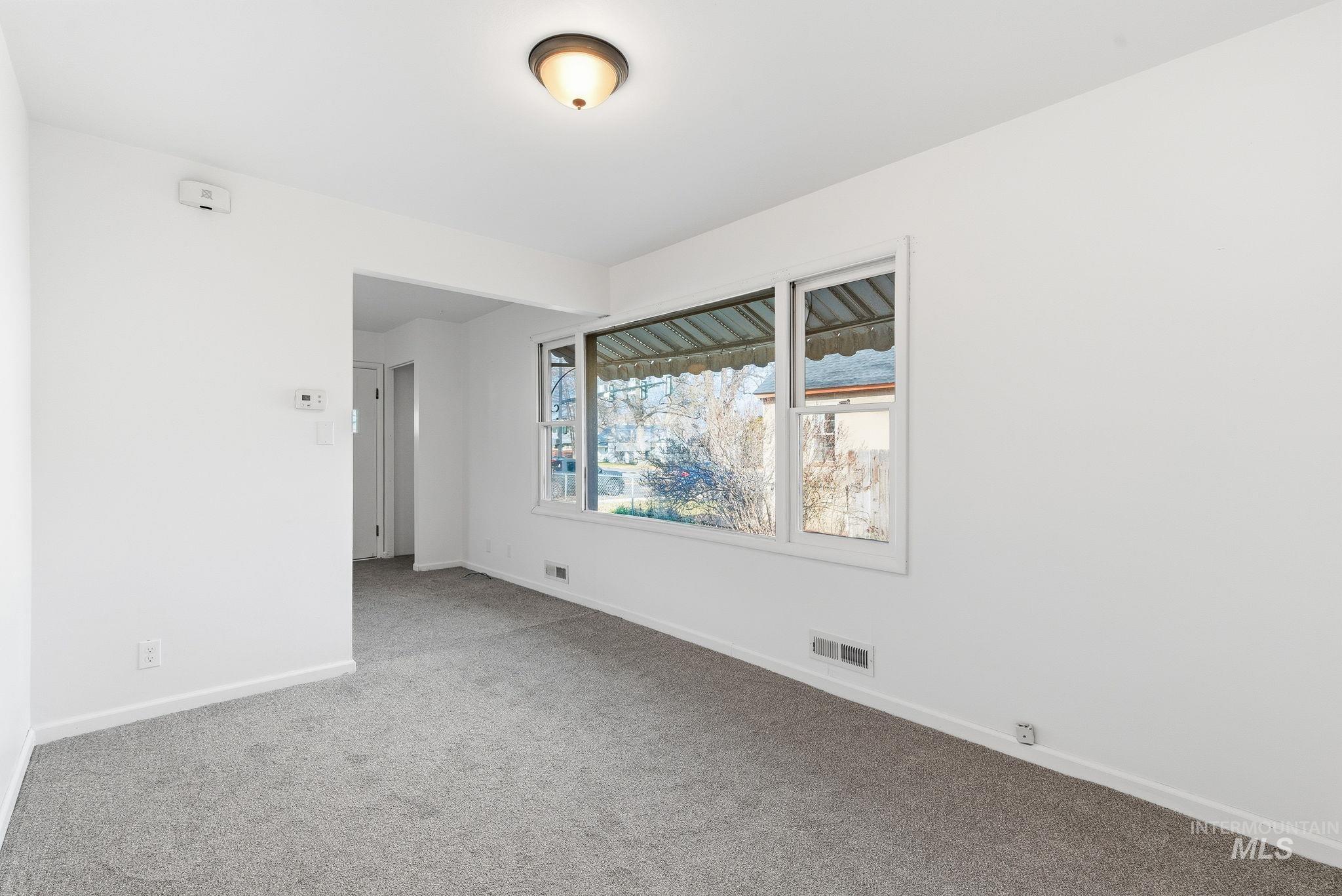 Unfurnished room featuring carpet flooring and baseboards