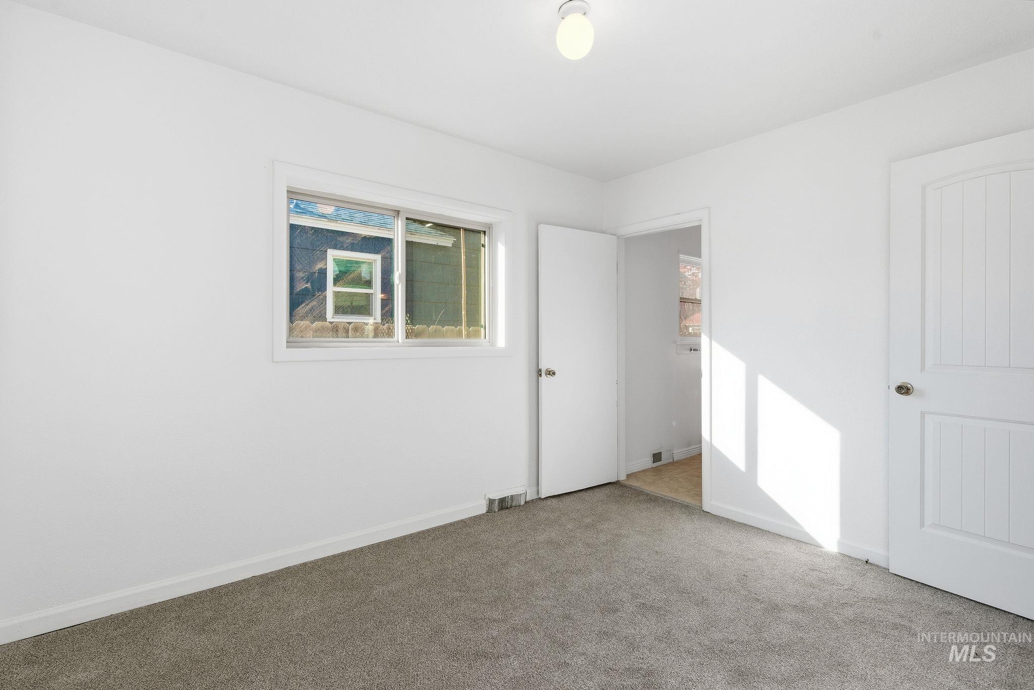 Unfurnished bedroom featuring carpet floors and baseboards