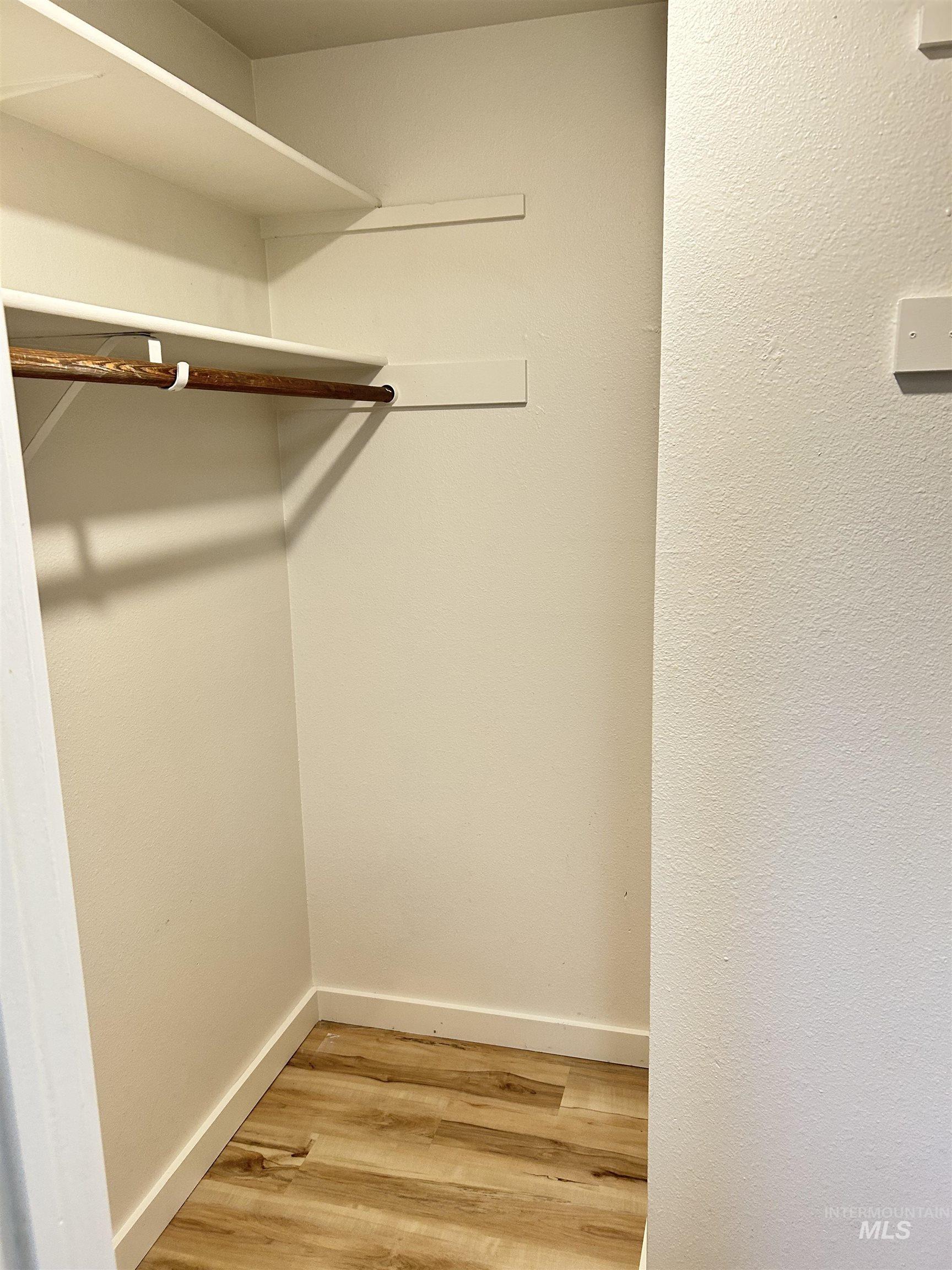 Spacious closet with light wood-style floors