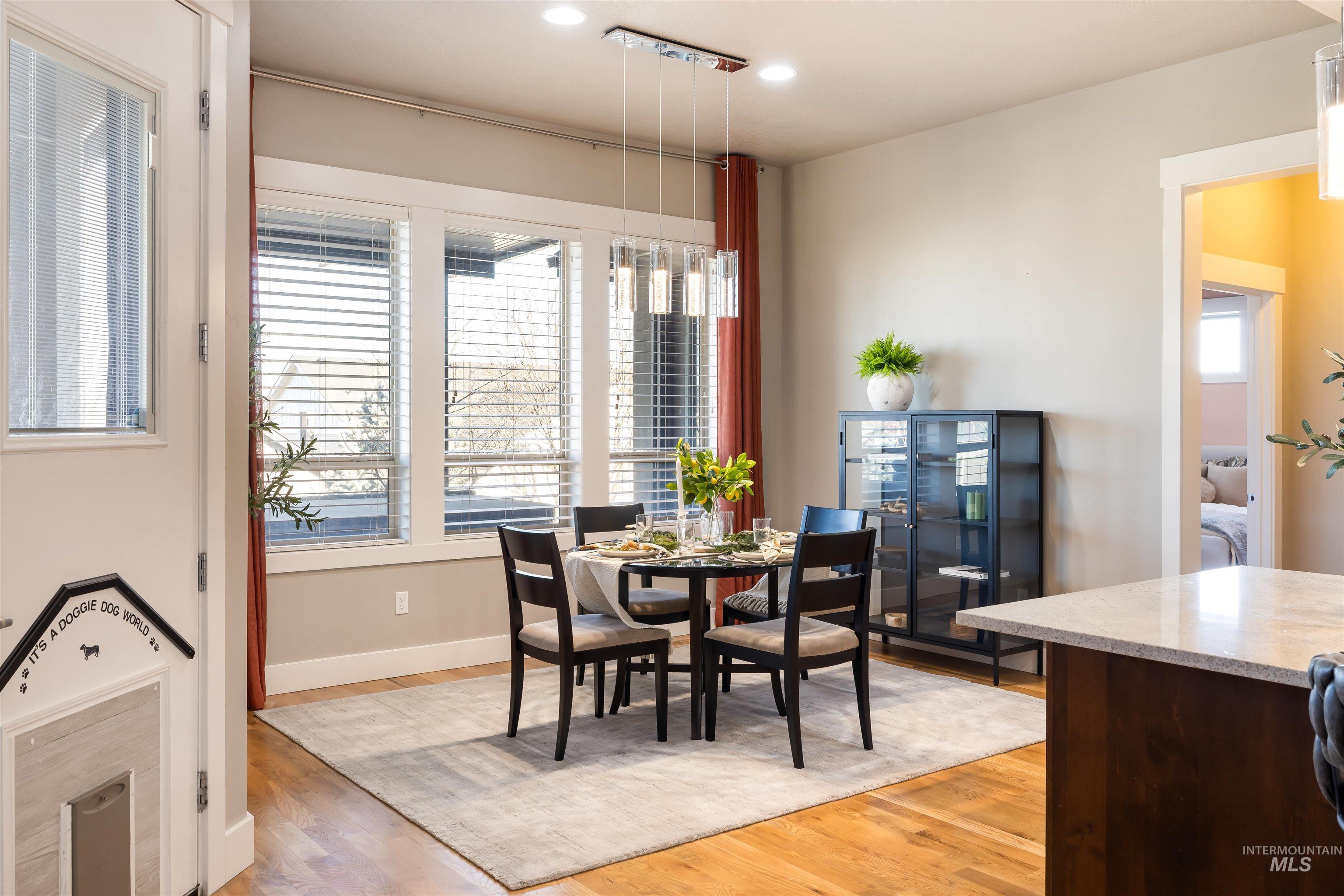 Dining area with light wood-style floors, plenty of natural light, and recessed lighting
