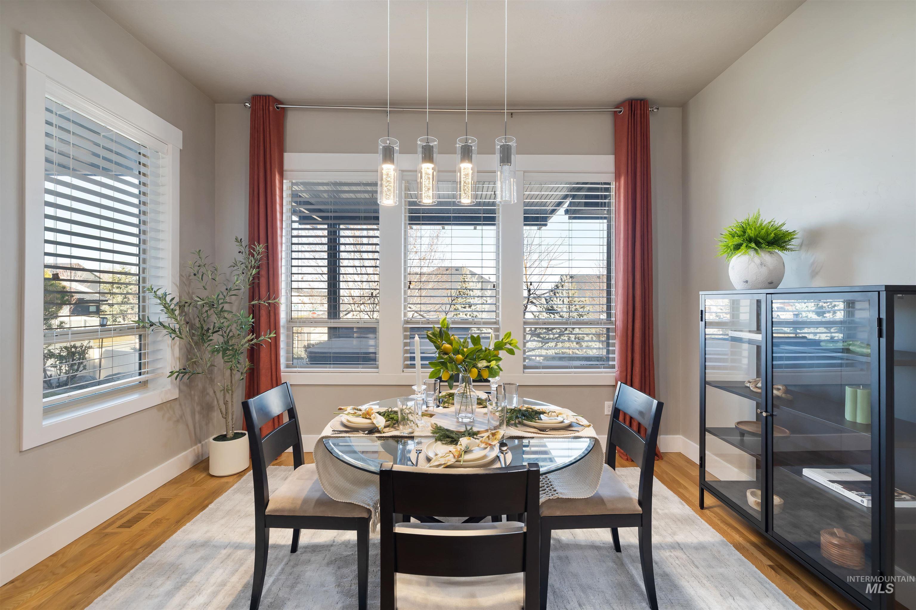 Dining space with healthy amount of natural light and wood finished floors