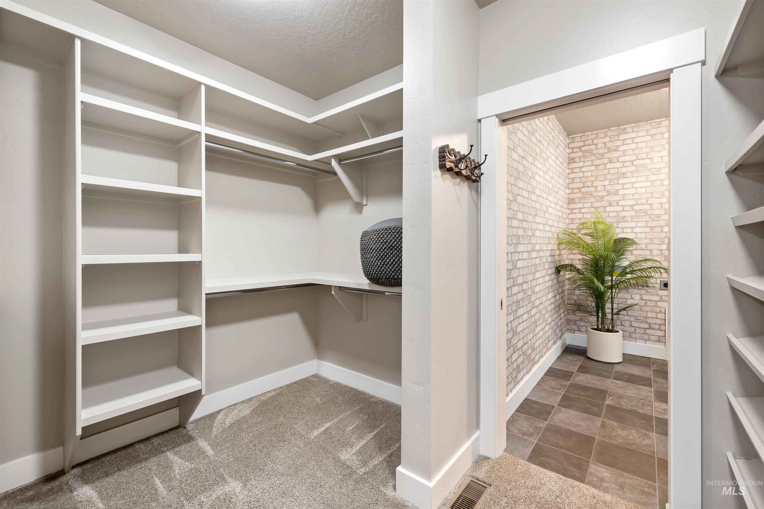 Walk in closet featuring light carpet
