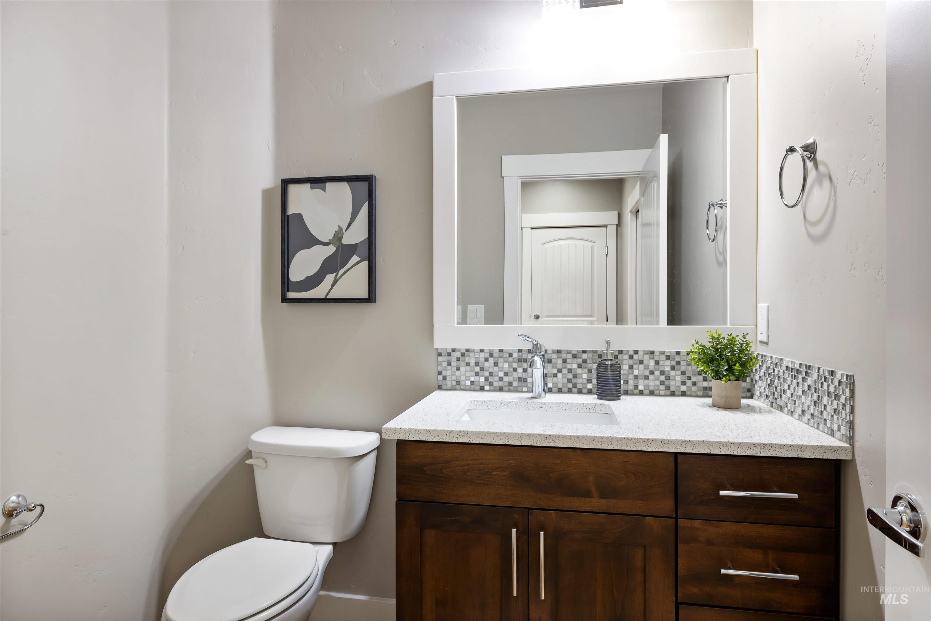 Half bath with backsplash and vanity