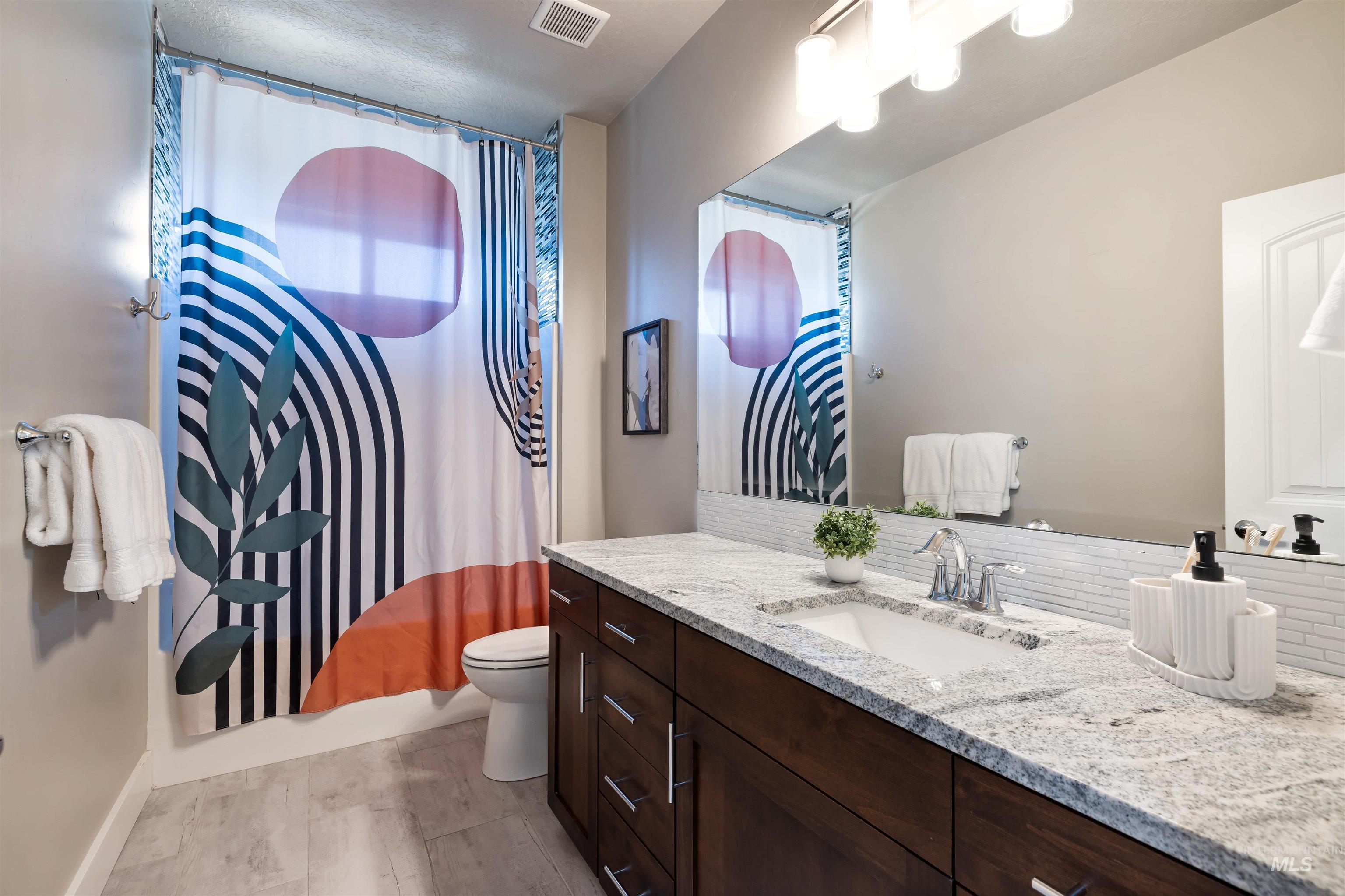 Bathroom featuring vanity and a shower with curtain