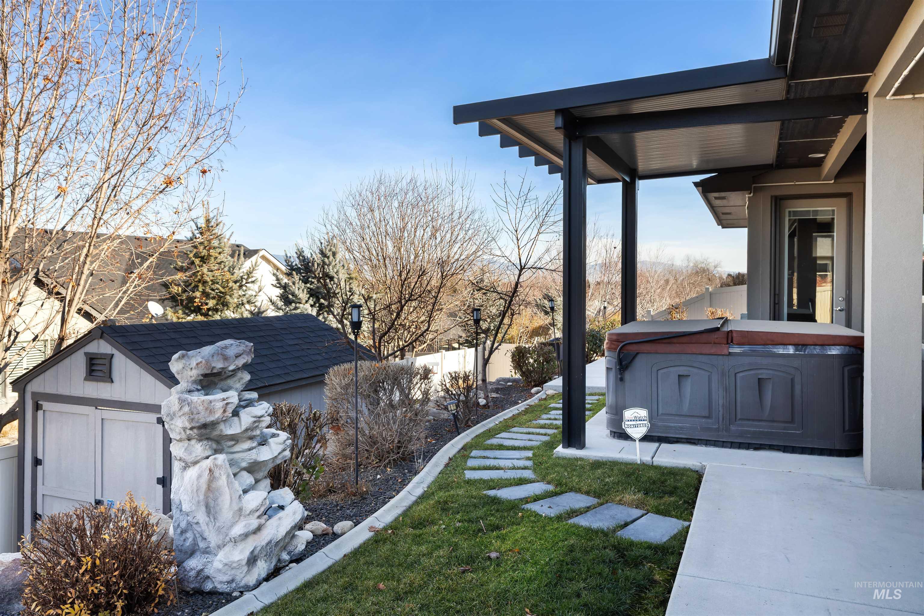 View of yard featuring a hot tub and a shed