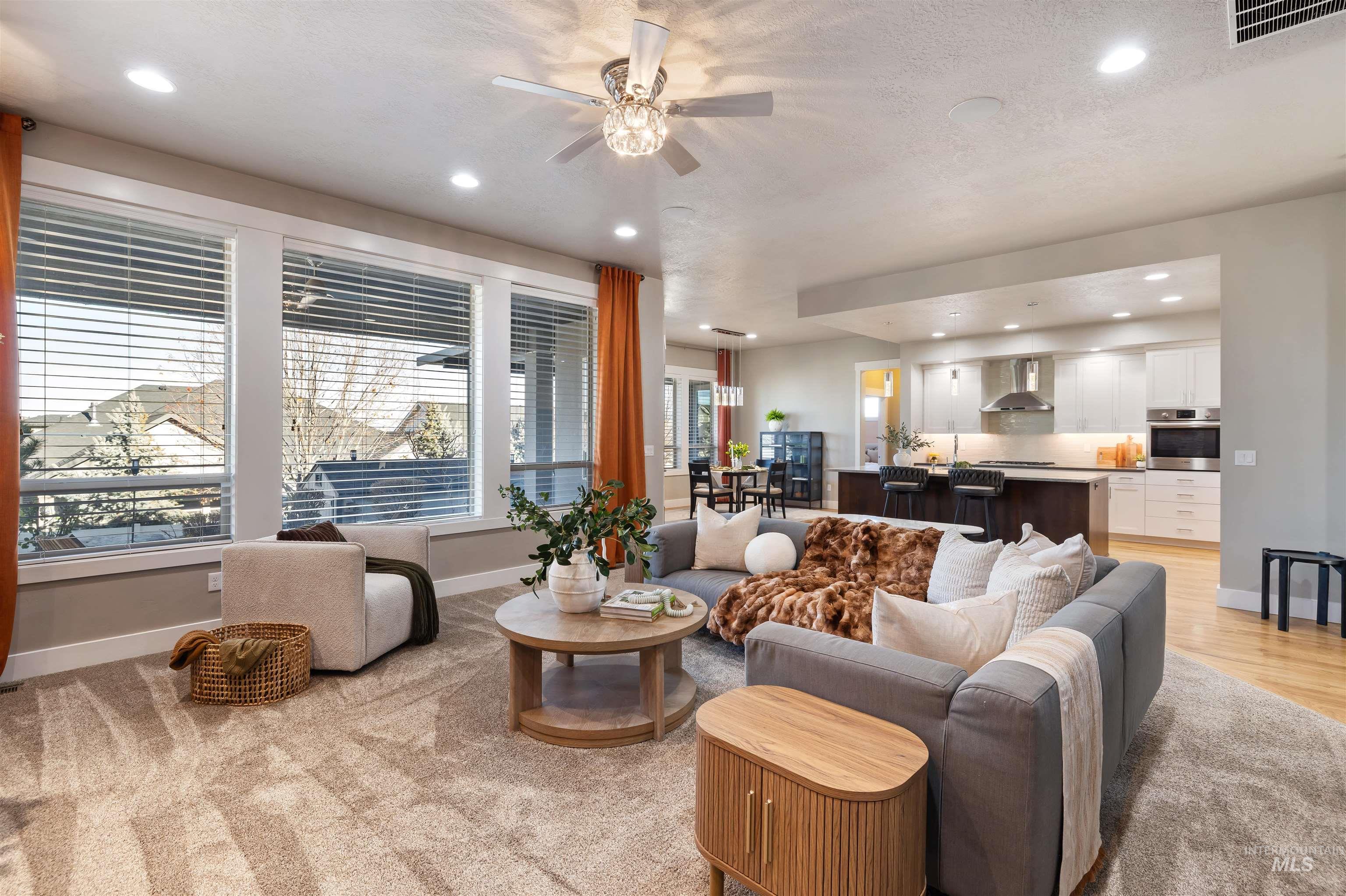 Living room with recessed lighting and a ceiling fan