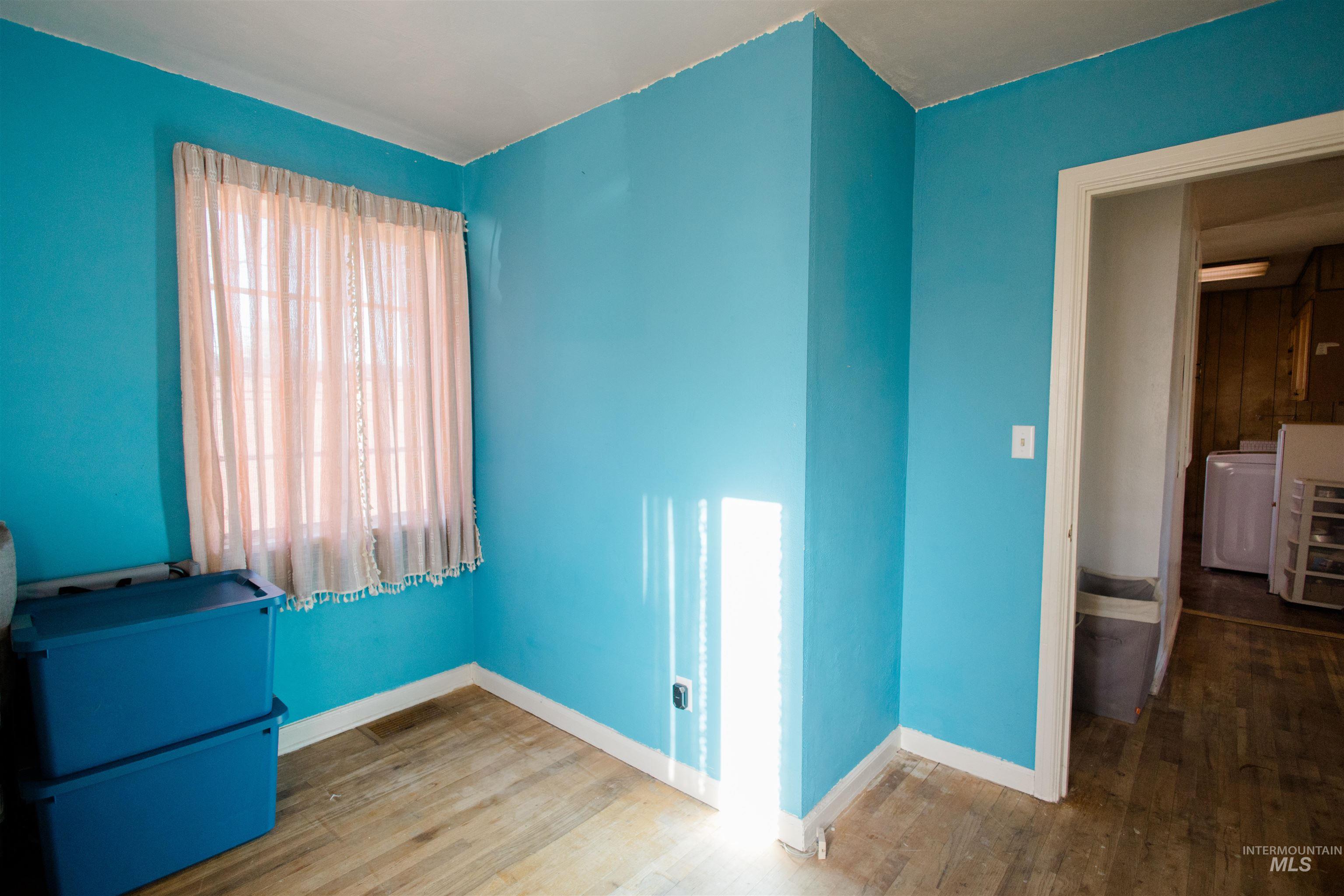 Spare room with hardwood / wood-style floors and washer / clothes dryer