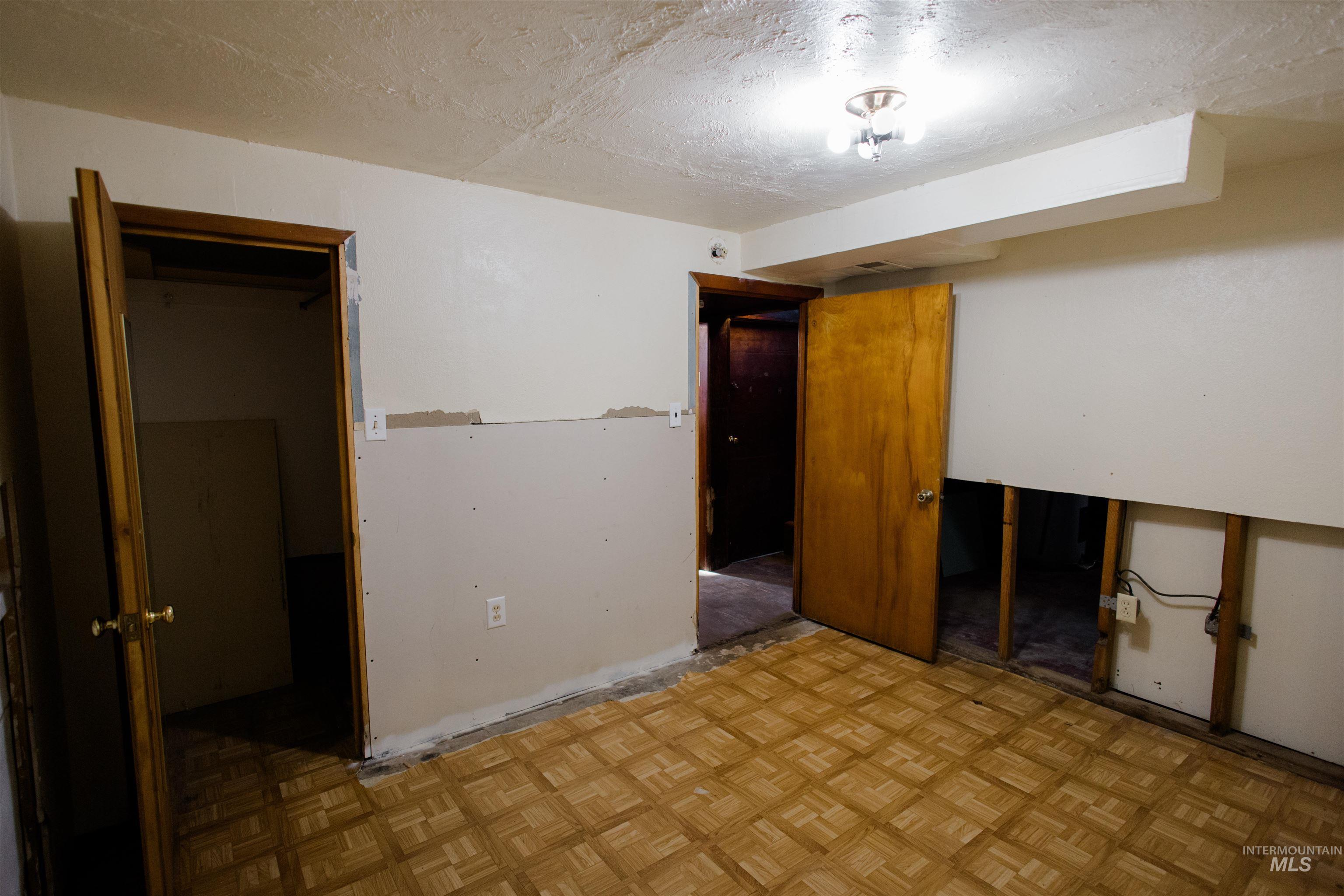 Unfurnished bedroom with a textured ceiling and a spacious closet