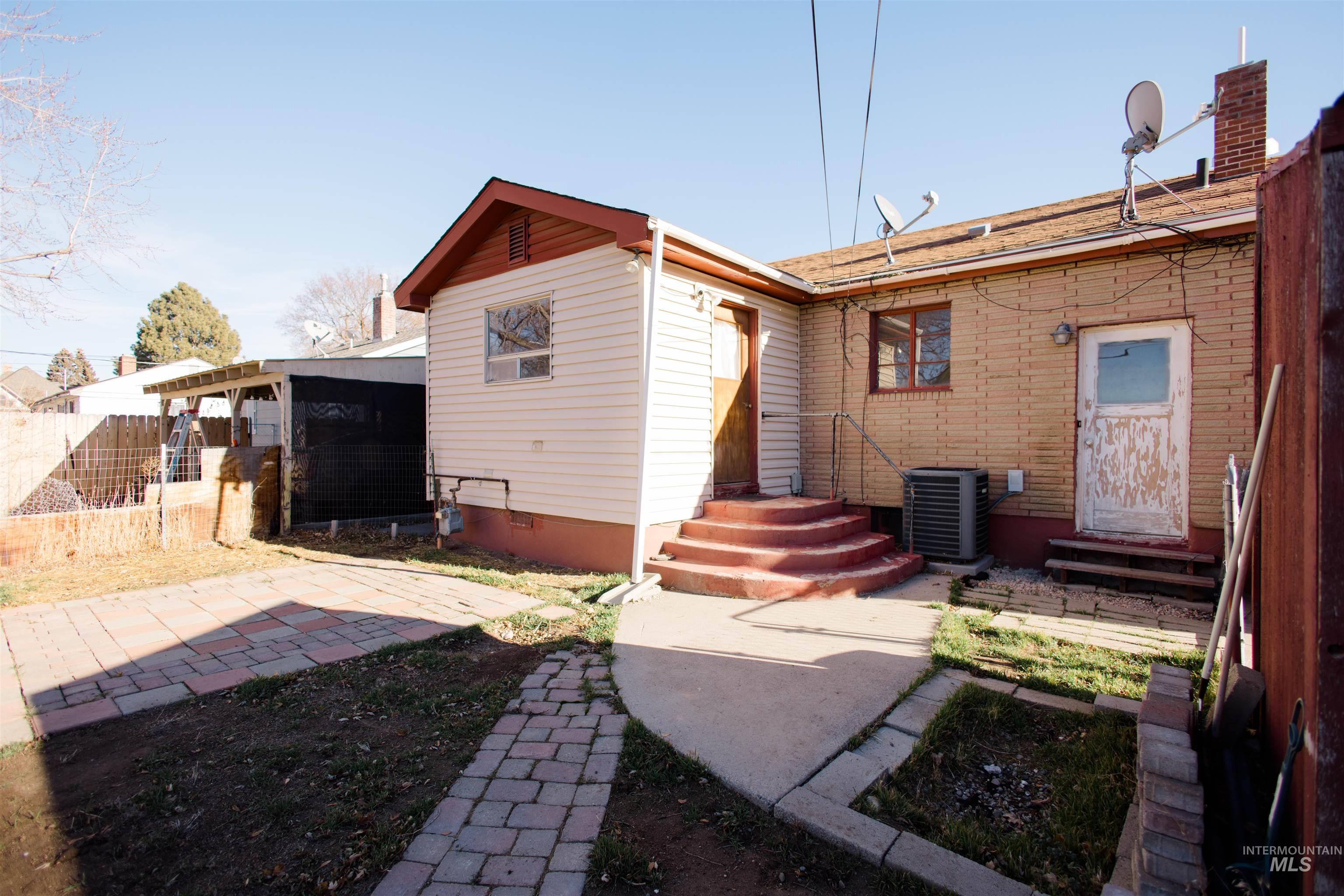 Back of property featuring entry steps, crawl space, and a patio