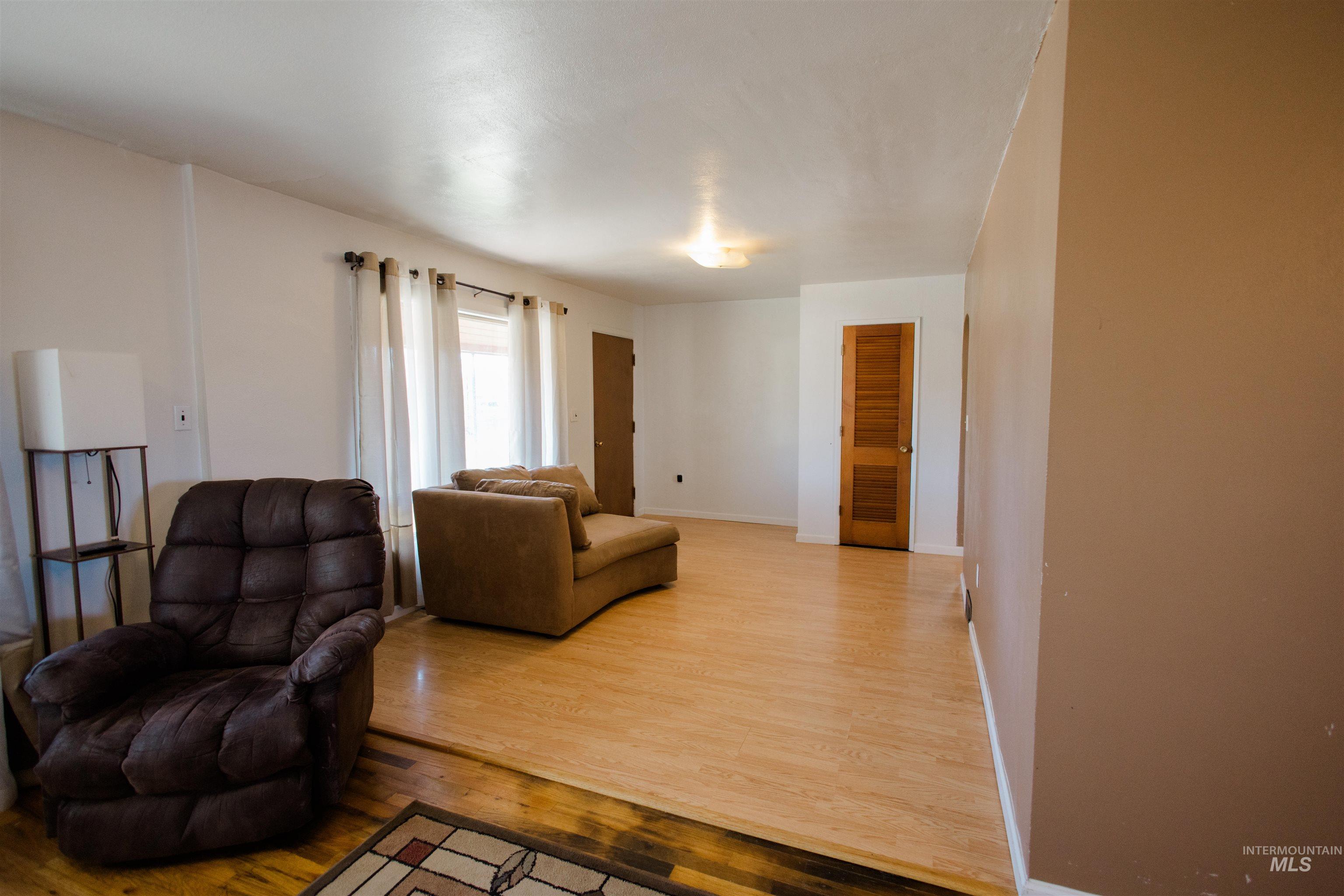 Sitting room with light wood-style floors and baseboards