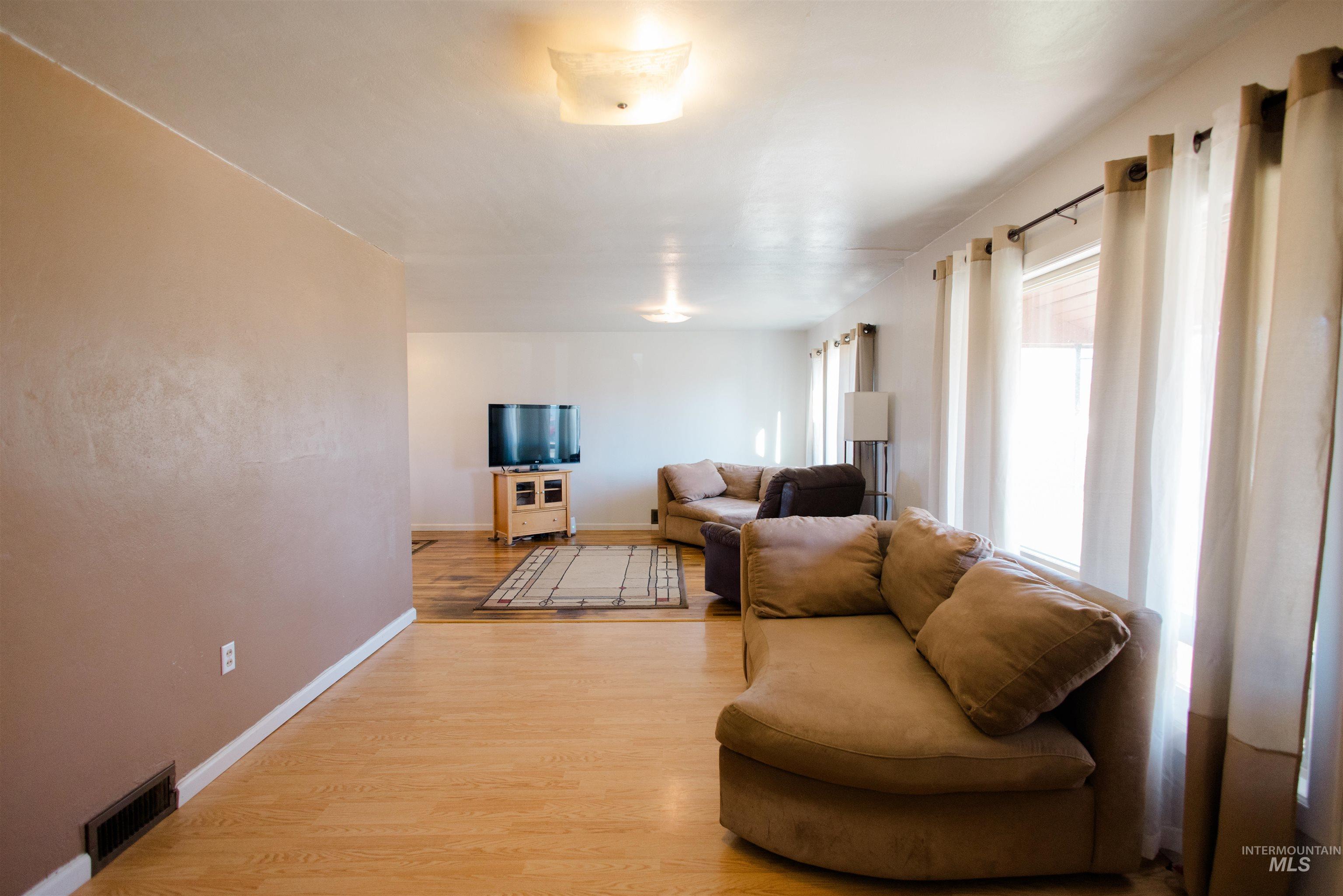 Living area featuring light wood-style floors and baseboards