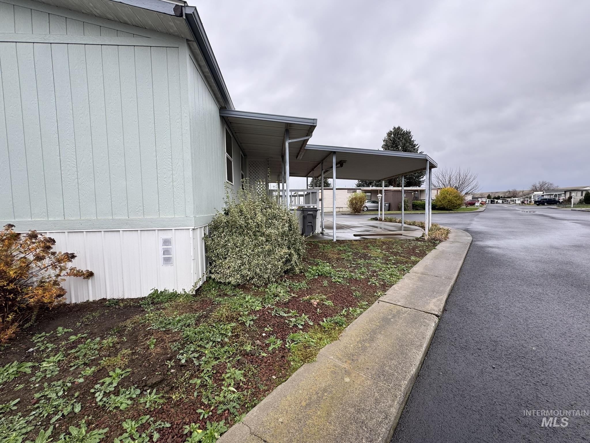 View of side of property with a carport