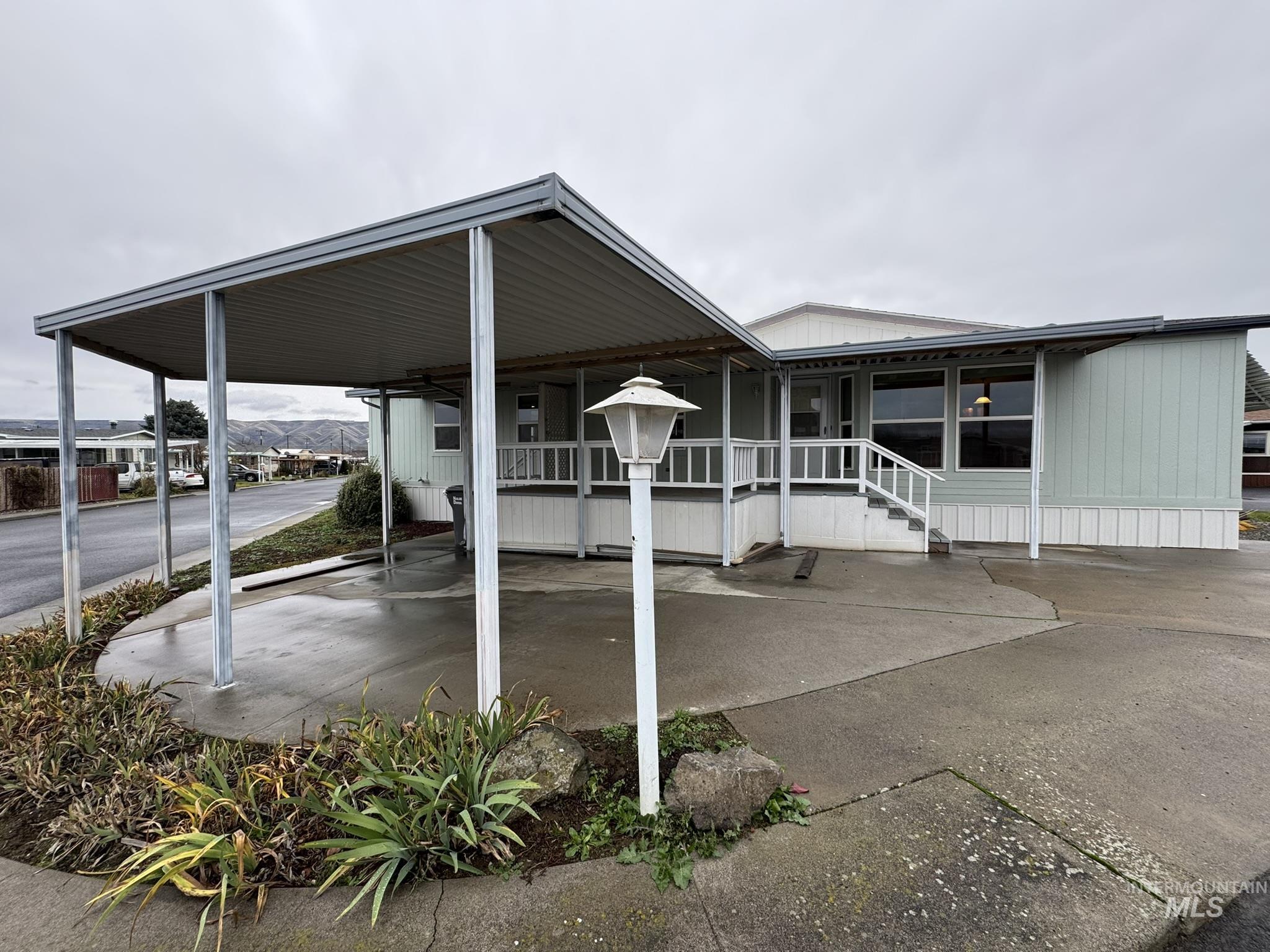 View of vehicle parking featuring a carport