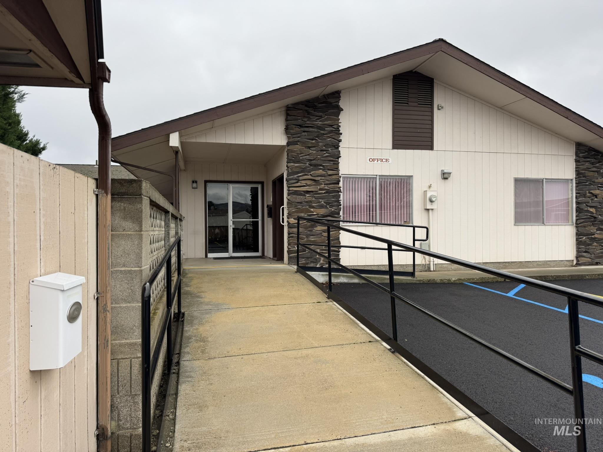 Property entrance featuring stone siding