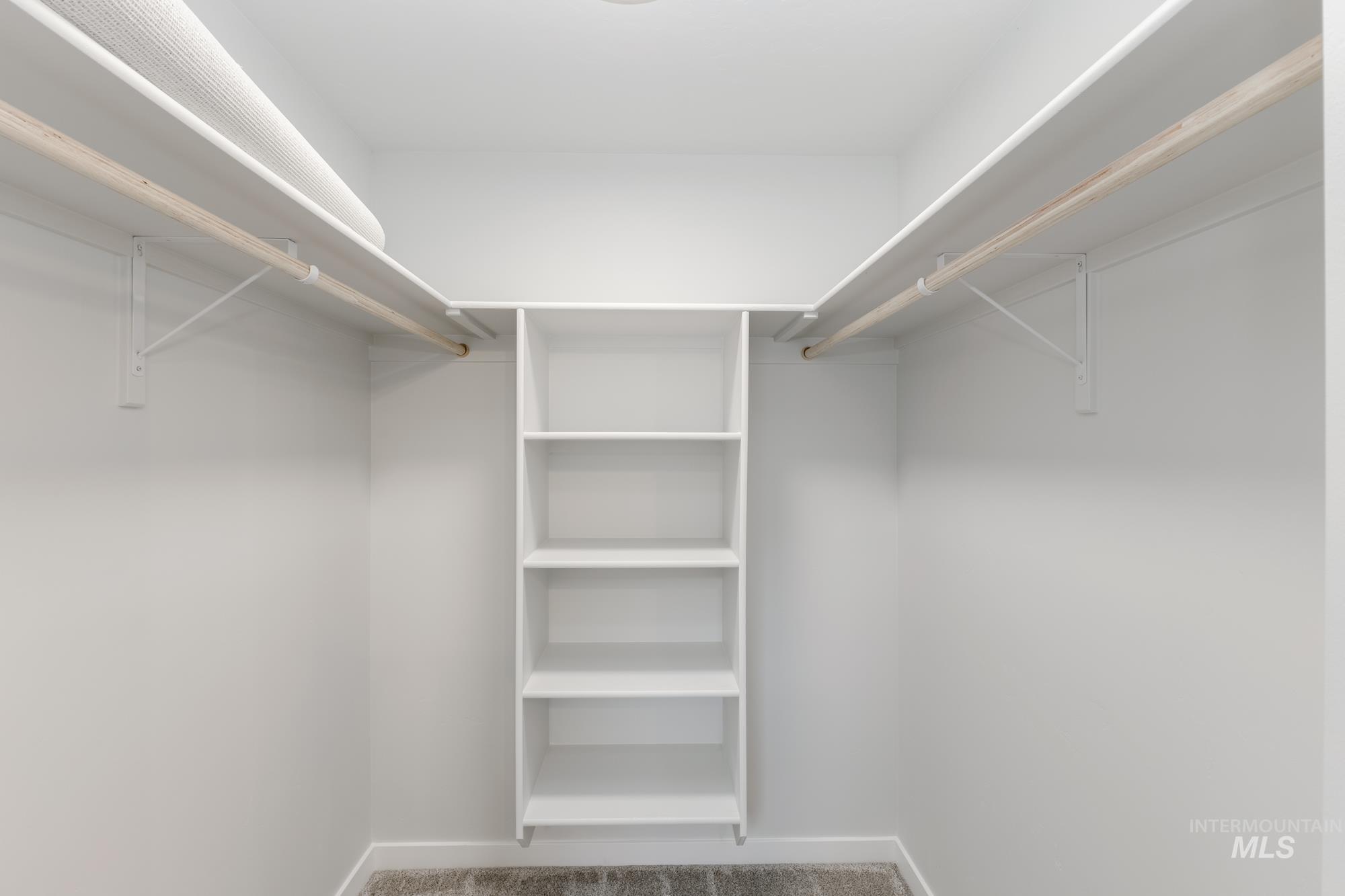 Spacious closet with light carpet