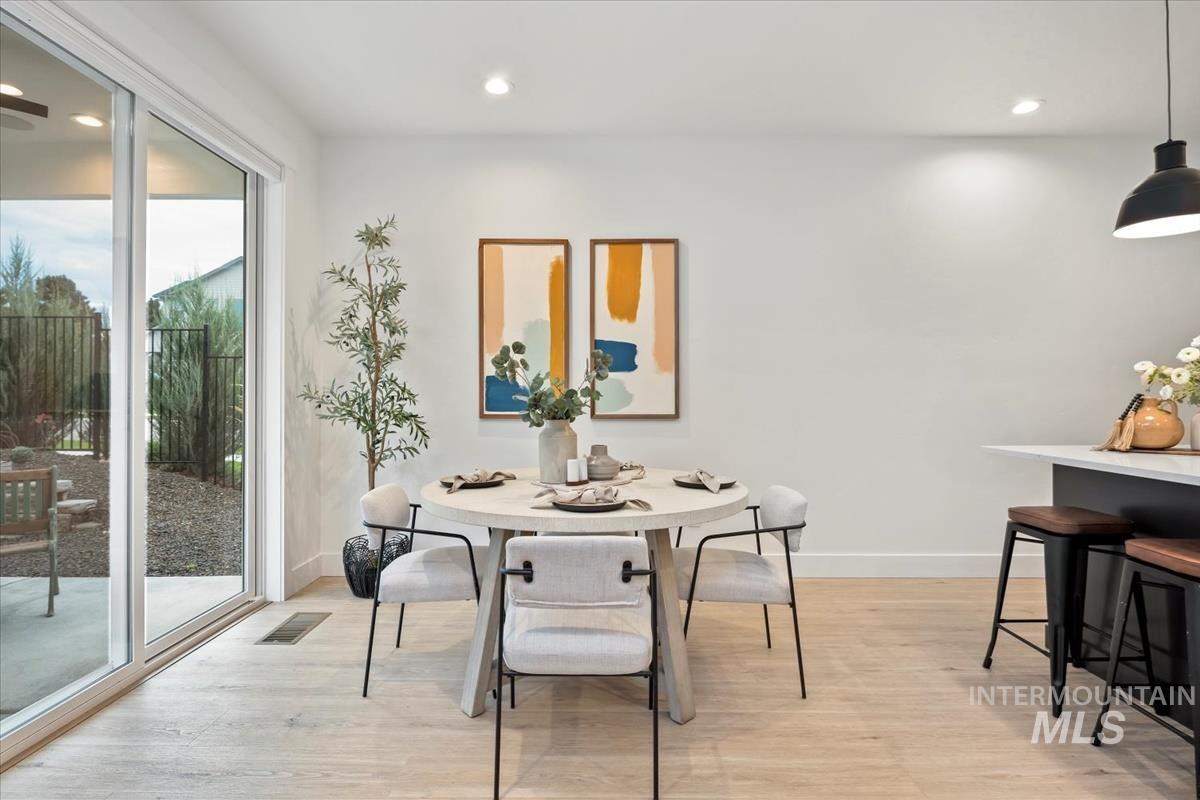 Dining space with recessed lighting and light wood finished floors