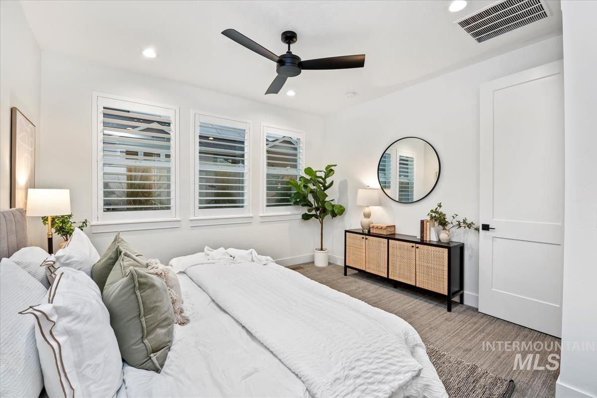 Carpeted bedroom with recessed lighting and a ceiling fan