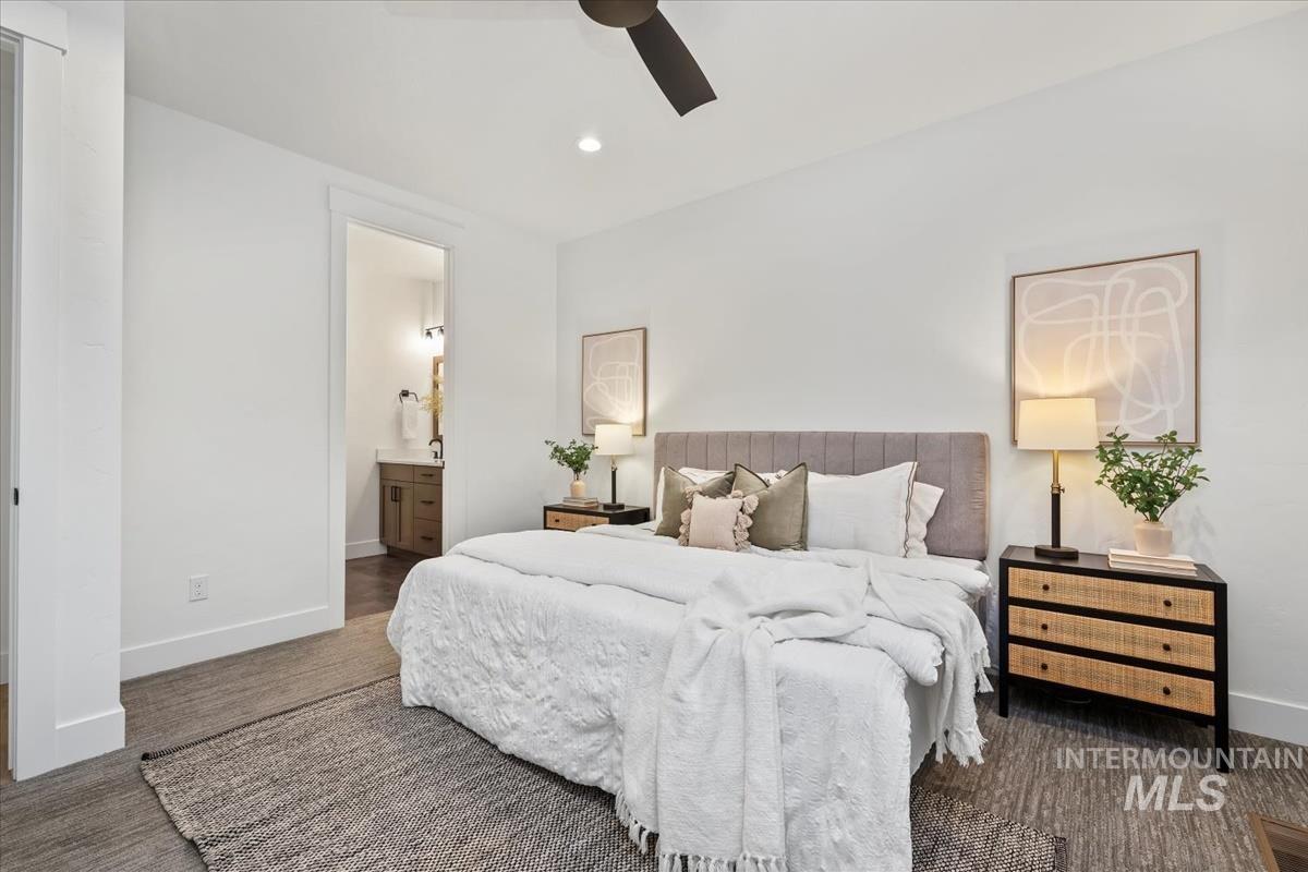 Bedroom with dark carpet, a ceiling fan, recessed lighting, and ensuite bathroom