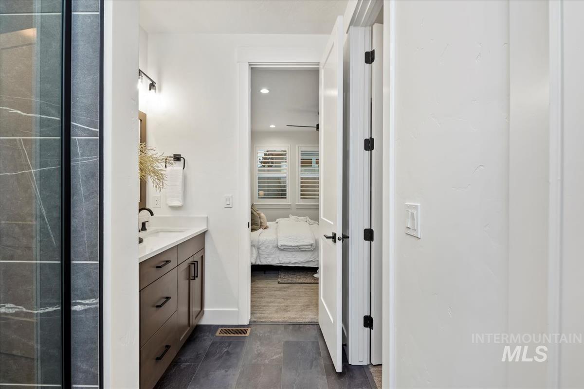 Bathroom featuring vanity, ensuite bath, and recessed lighting