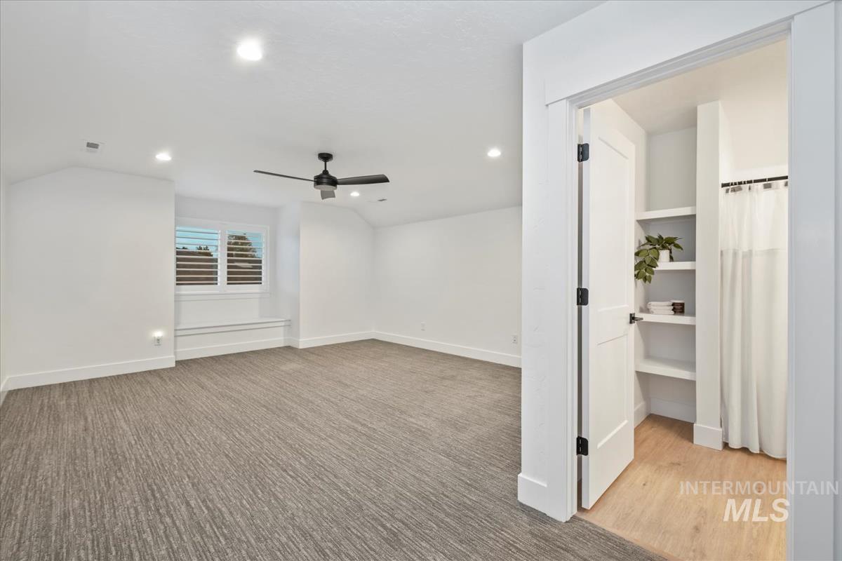 Interior space with recessed lighting, a ceiling fan, ensuite bathroom, and light wood-style floors